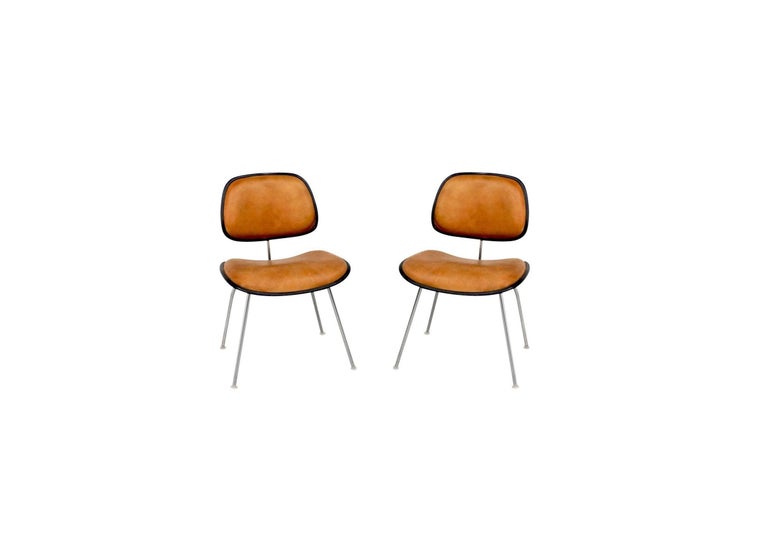 Hard to find an incredible set of 16 classic EC-127 padded DCM dining chairs designed by Charles and Ray Eames for Herman Miller, circa 1971-1981. This version was developed in 1969 in an effort to sidestep the challenges of the glued shock mounts