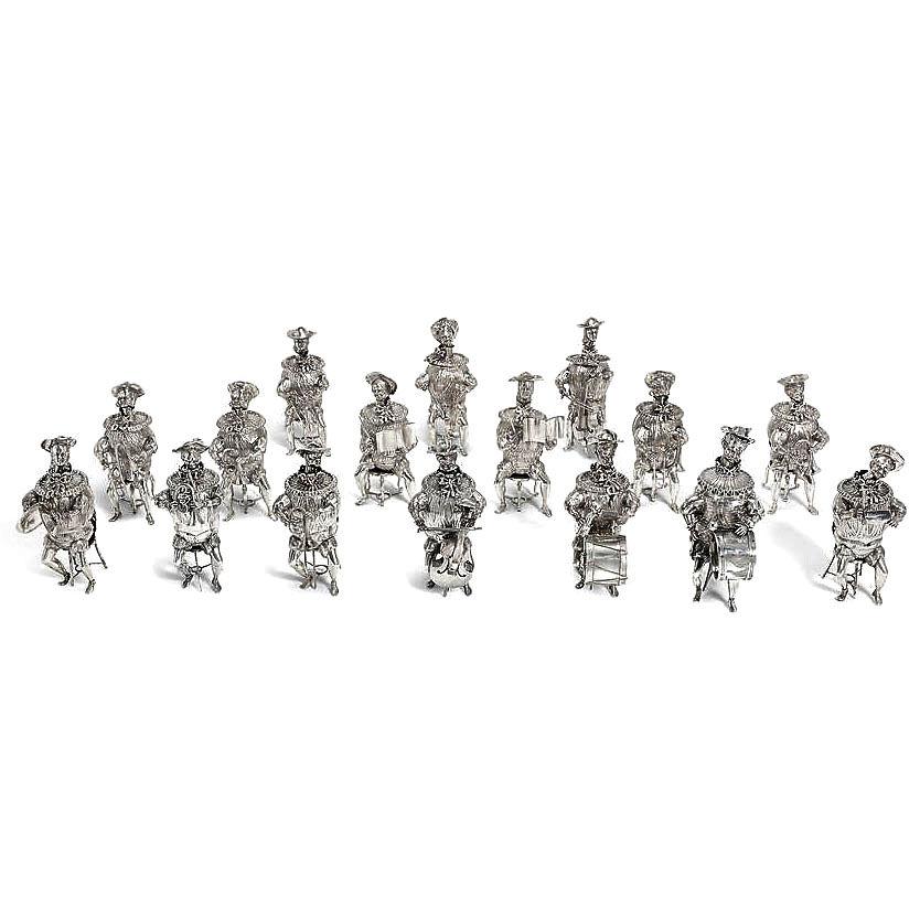 A magnificent and rare set of 16 Antique solid Silver Musician Table Ornaments / Figures. This Orchestra of Figures is a modern re-imagining of Renaissance Novelty Beakers in the form of figures. These figures have removable ribbon tired ruffled