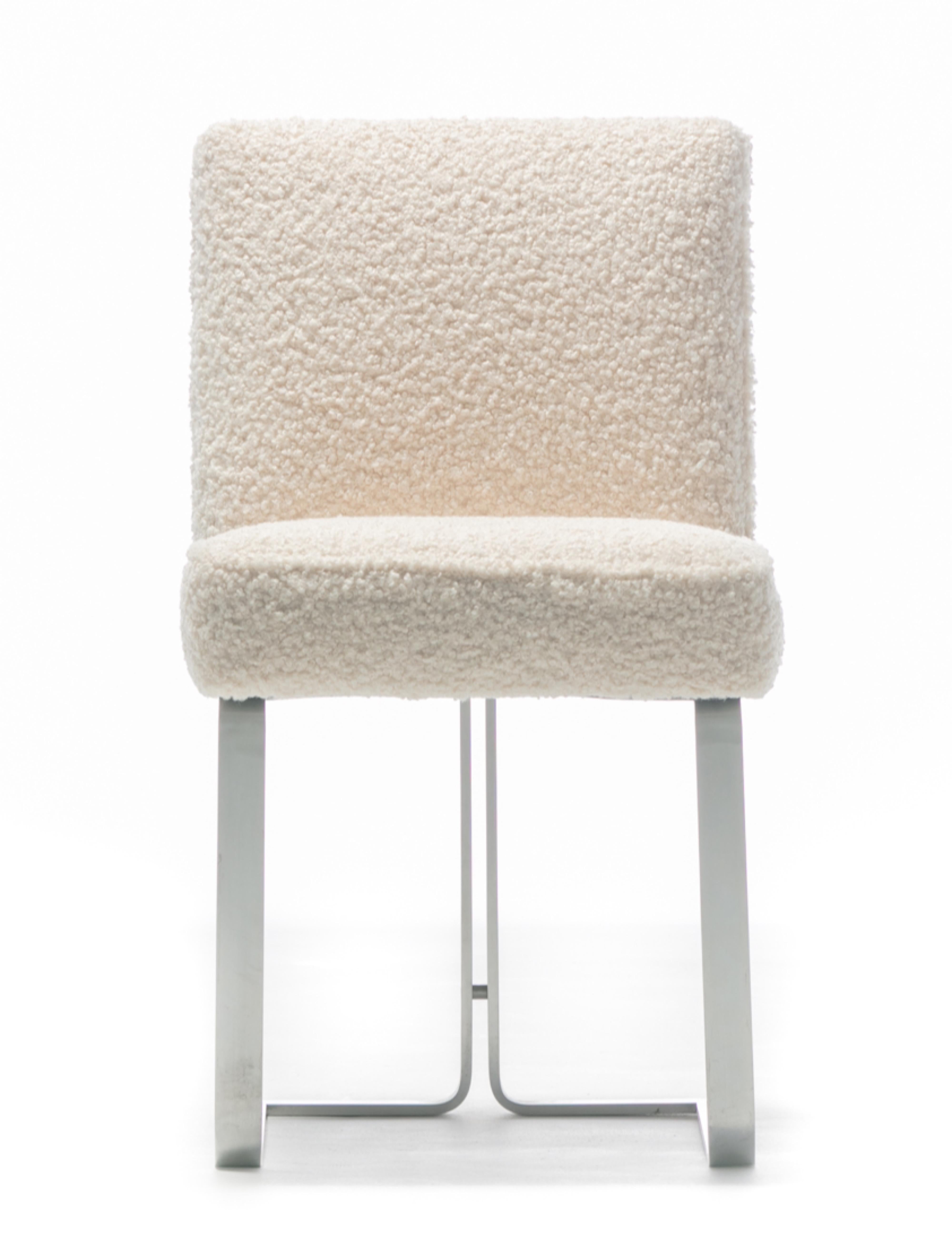 Early 1950s Vladimir Kagan set of 16 stainless steel dining side chairs professionally reupholstered in soft ivory bouclé. This rare set was designed in the 1950s by Vladimir Kagan during a ten year joint venture with Hugo Dreyfuss (textile