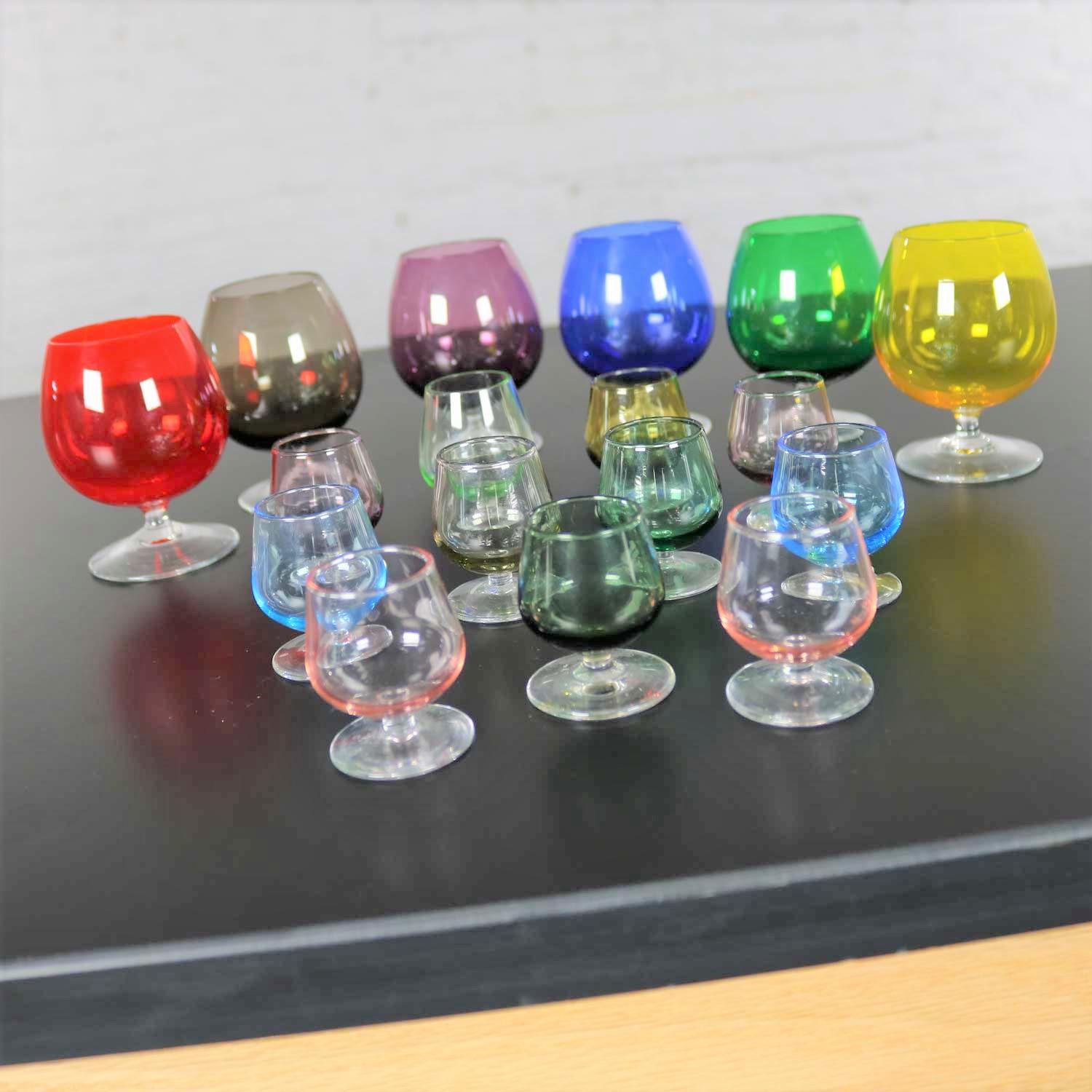 Awesome set of 17 multi-color snifter cocktail glasses in eight different colors and two sizes, small and very small. They are in fabulous vintage condition with no chips, cracks, or chiggers. Please see photos, circa 1960s.

These snifters are