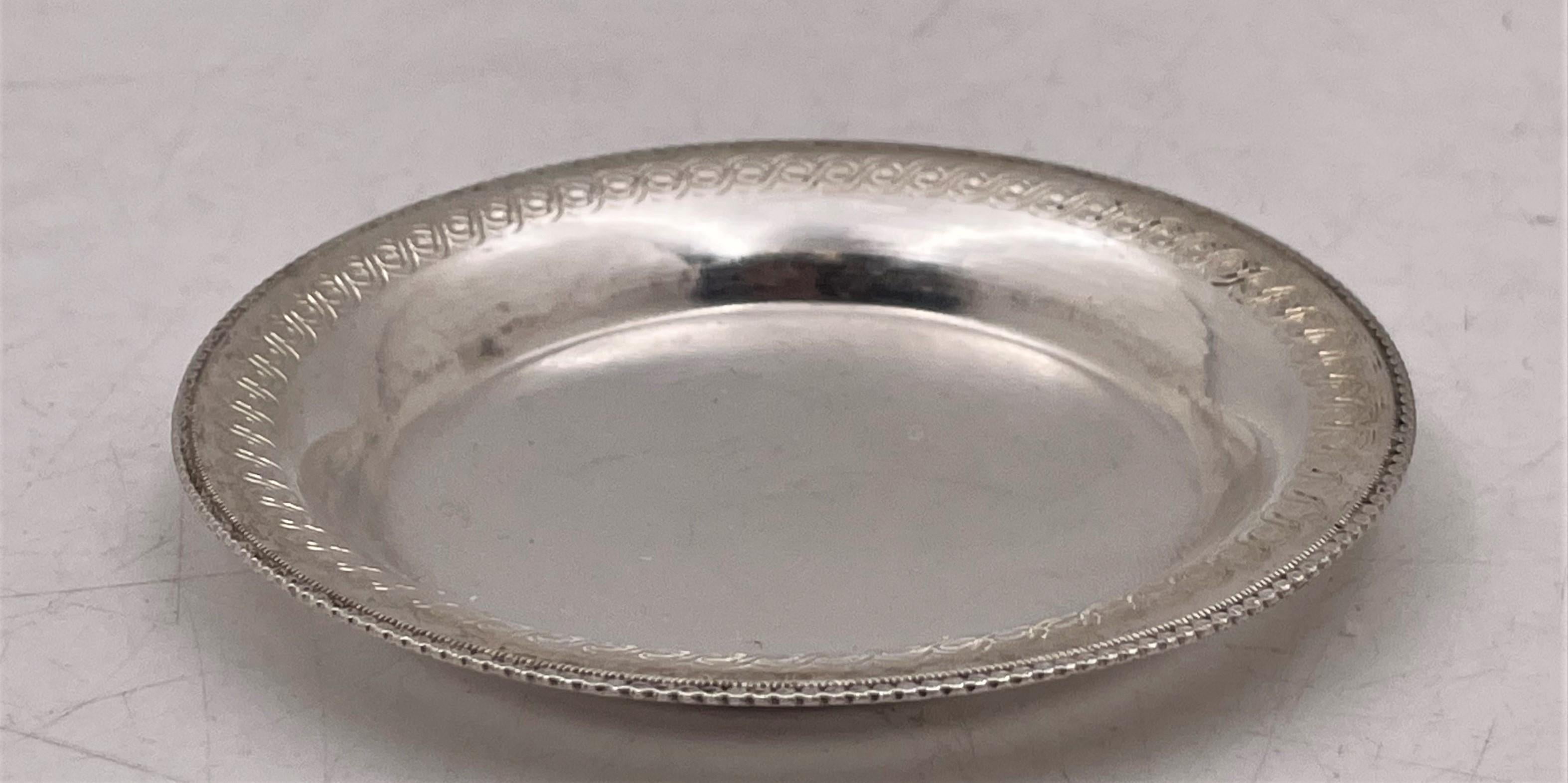 Set of 18 Egyptian silver coasters, made in Cairo circa 1943-1944, with a finely engraved geometric motif adorning the rim, measuring 3'' in diameter (inner diameter 2 1/8'') by 1/4'' in height, and bearing hallmarks as shown. Total weight is 16.2