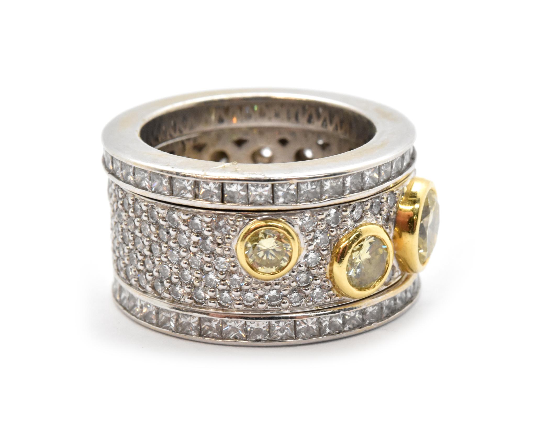 This set features 3 bands set with diamonds. The larger, central band is made in 18k white gold. It features 3 natural yellow diamonds set into 18k yellow gold bezels. The largest diamond weighs 0.74ct (SI1), the second weighs 0.32ct (SI2), and the