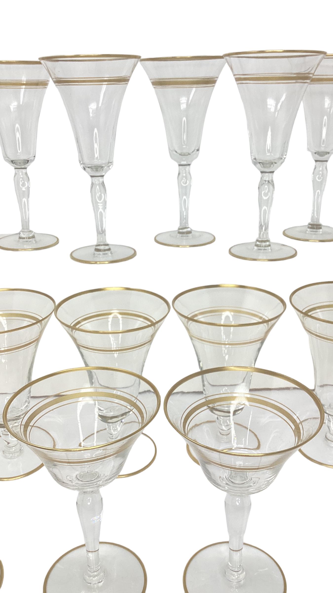 Set of 18 Vintage Gold Rimmed Glass Stemware. Set consists of 6 champagne coupes, 6 red wine glasses, 6 water goblets which can also be used for white wine. The coupe measures 3.75