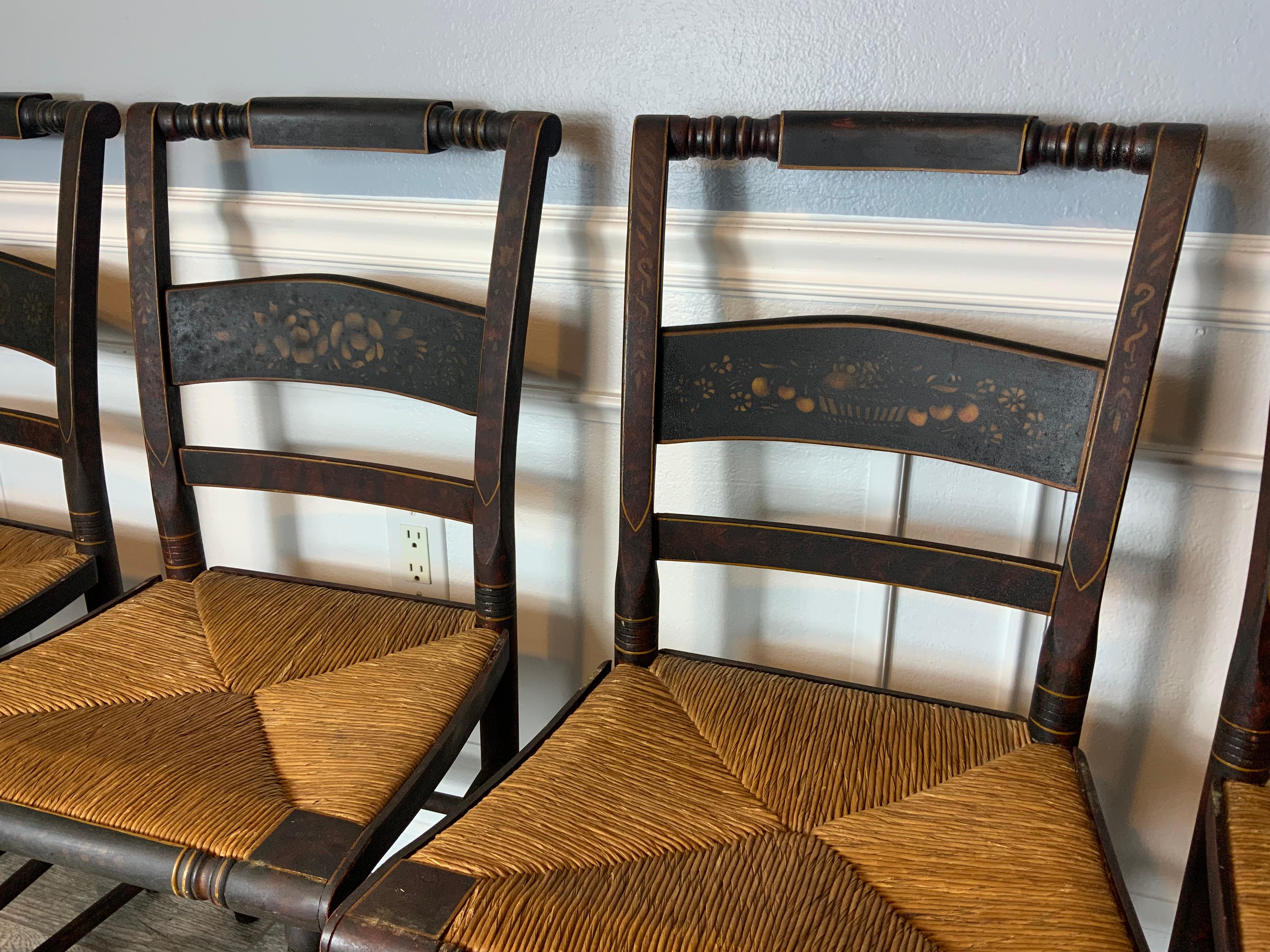 Exceptional set of four 1840’s paint decorated and stenciled rush seat chairs in completely original condition. All chairs are tight and solid and all of the rush seats are in great condition. No damage old breaks or repairs whatsoever on any of