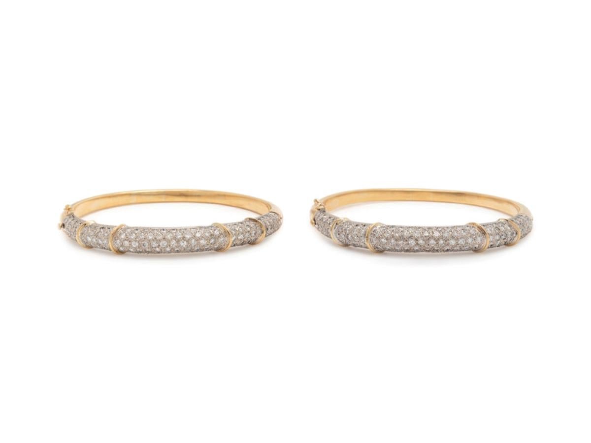 Ces magnifiques bracelets se composent de nombreux diamants ronds de taille brillant, pesant environ 10,00-11,00 carats au total, sertis dans de l'or blanc 18 carats joint à de l'or jaune 18 carats et articulés avec un fermoir latéral. 

