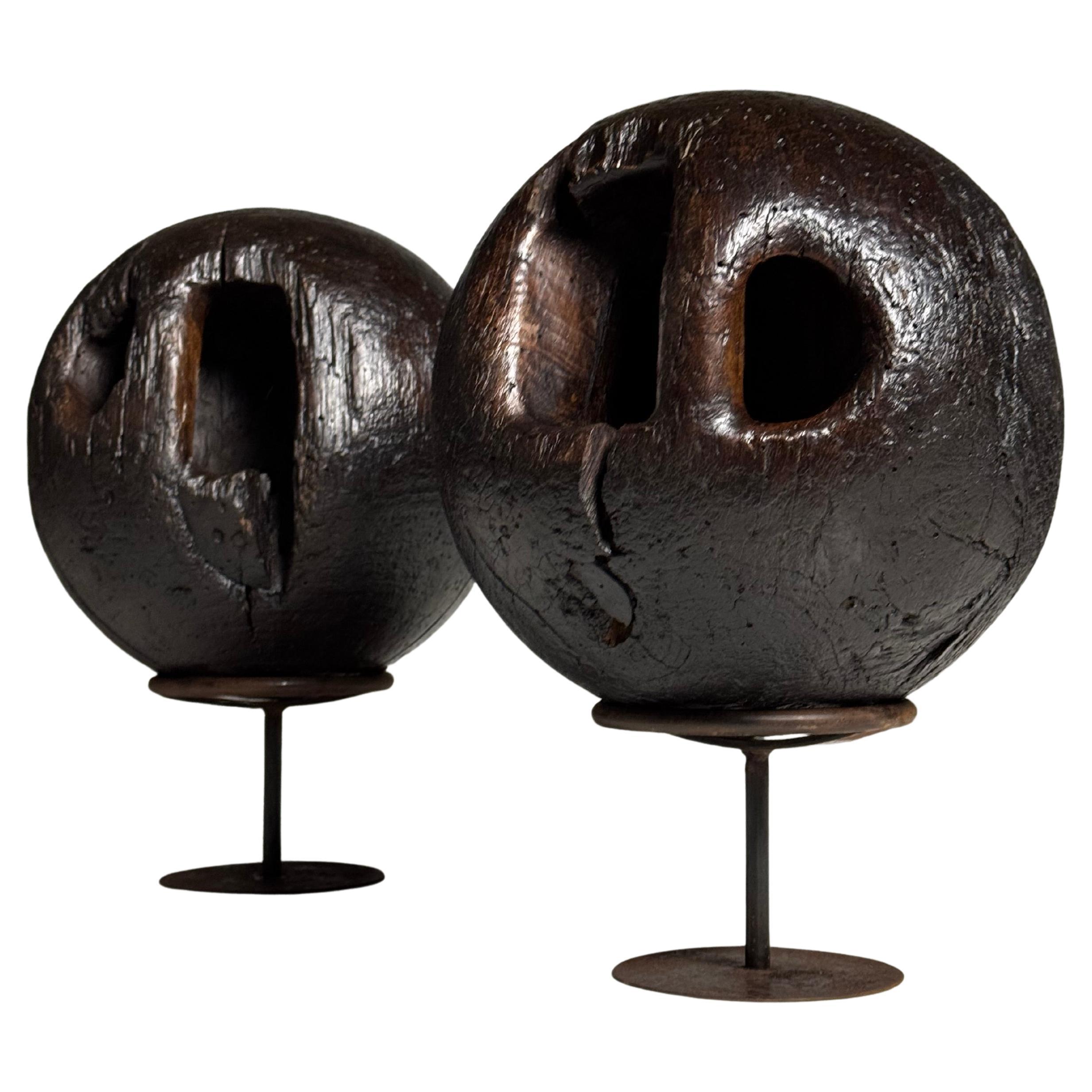 Set of 18th century bowling balls on wooden stand