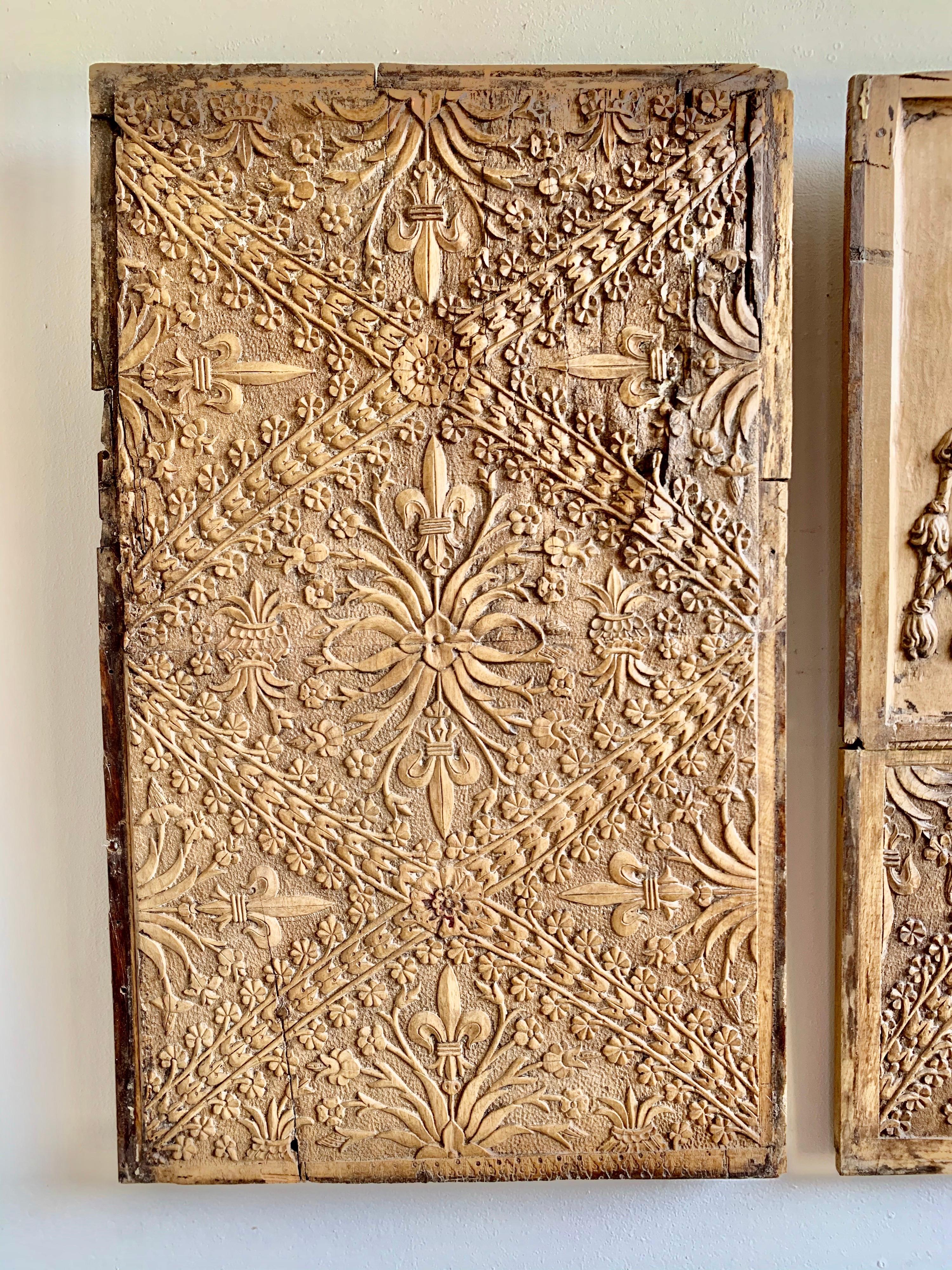 Set of 18th century Spanish wood panels with fine hand carved details throughout. The center panel has a shield that is draped with carved tassels. Crossed swords are in the center with fleur-de-lis throughout. The hat with tassels is the emblem of