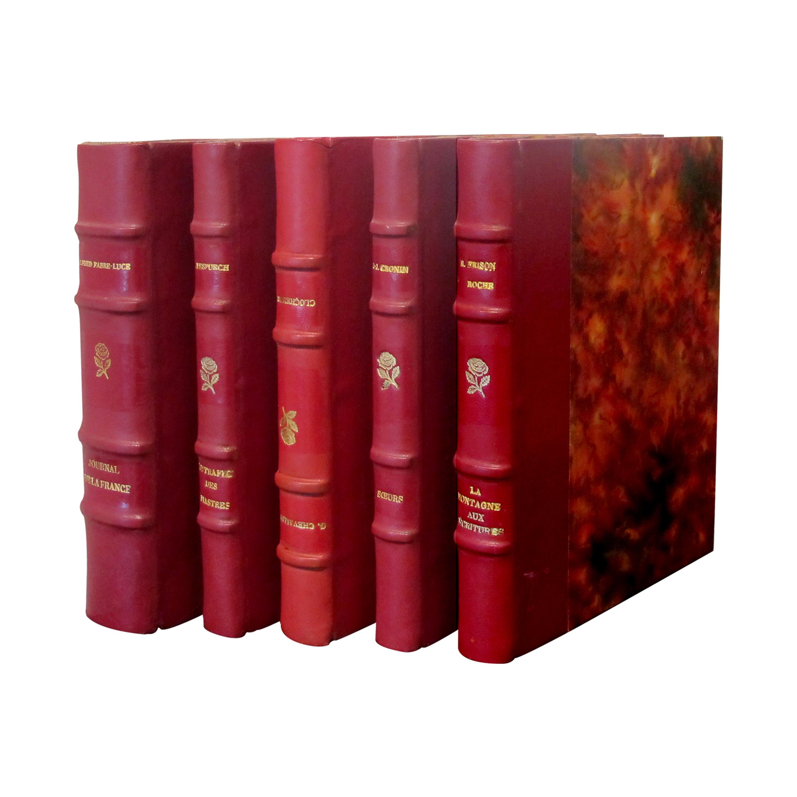 A beautiful set of 19, highly-decorative, French red leather-bound books which were printed in small editions with the dates ranging from the 1920s to the 1960s. The books are written by various authors and printed by a number of different