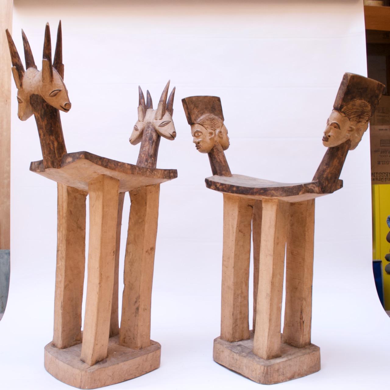 Two hand carved hardwood stools with pyrographic decoration from the Sikire Kambire School of the Gaoua region of Burkina Faso (Lobi People, circa 1947). Composed of four legs supported by a square base with seats adorned at each end with two