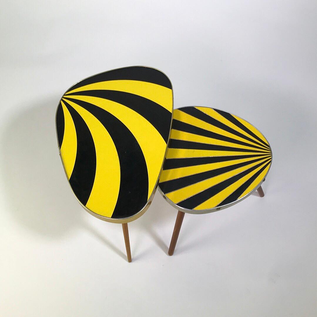 Psychedelic kidney tables is probably the most fitting name for this cool 1950s design. 

Two different sized tables made from plywood, clear coated beech legs and Formica intarsia. The large table has a belt of brass covered belt on the edge and