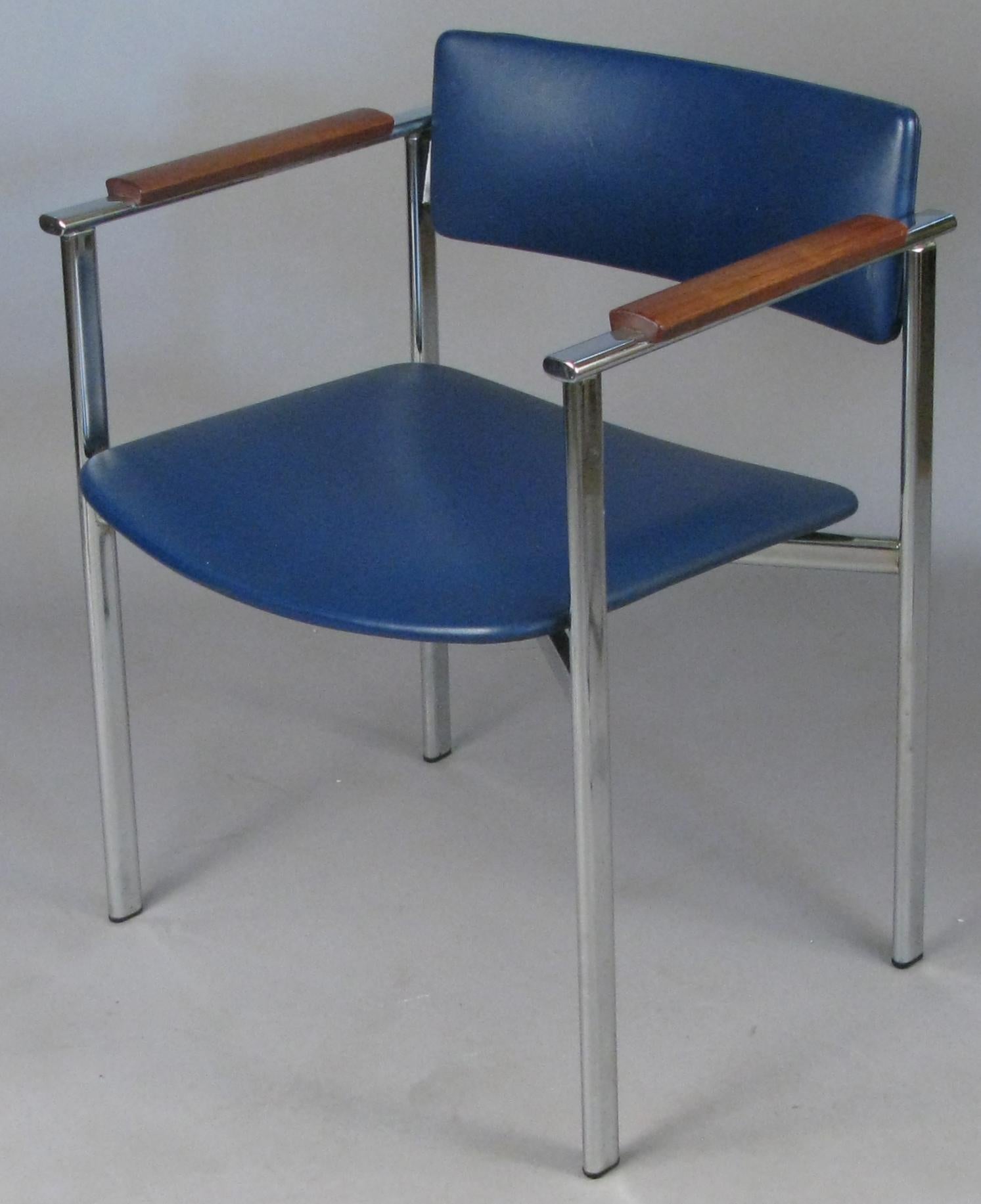 A beautiful set of vintage 1960s chrome dining chairs with walnut arms designed by Ilmari Tapiovaara, made in Finland and imported by Stendig. In their original blue vinyl upholstery. Great design in these Classic modern chairs. The set includes a