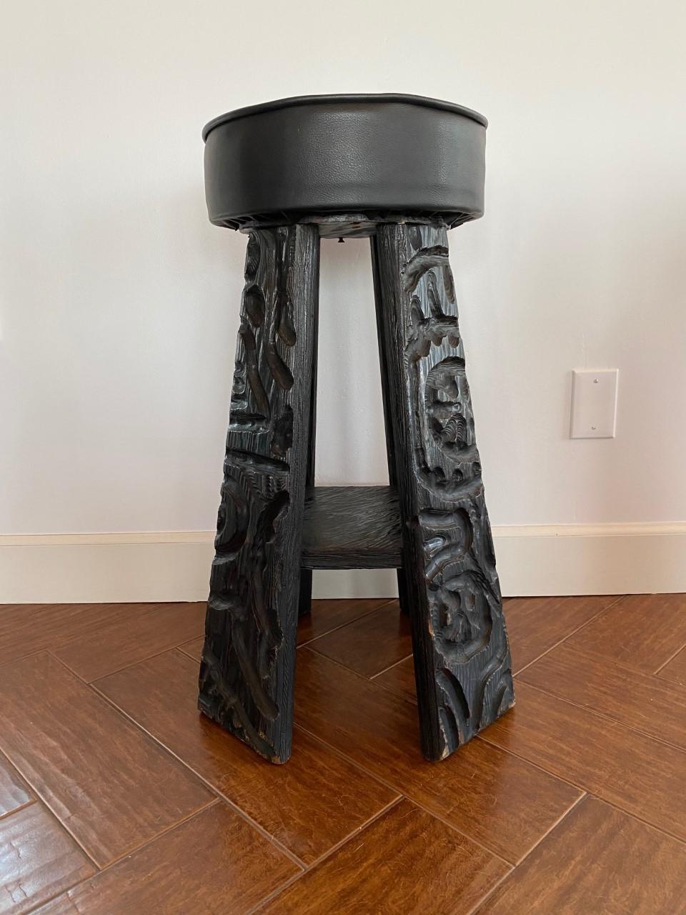 Set of 2 solid wood Tiki bar stools. Each stool has 4 paneled legs that have been carved in a beautiful South Pacific primitive style. This set will enhance your Tiki decor and accentuate other decor styles that accommodate strong and beautiful