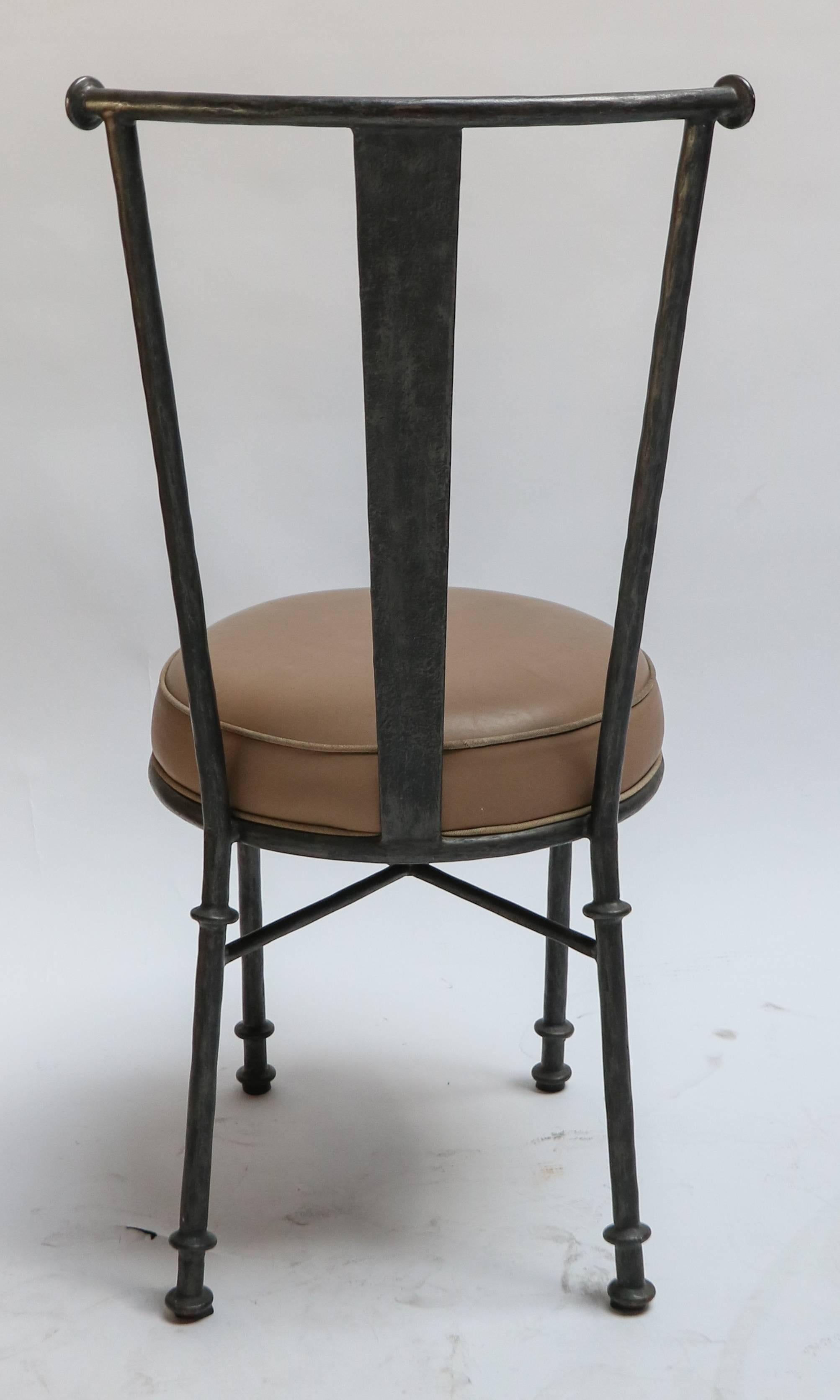 Set of 1980s handcrafted iron chairs, eight side chairs upholstered in brown / tan leather.