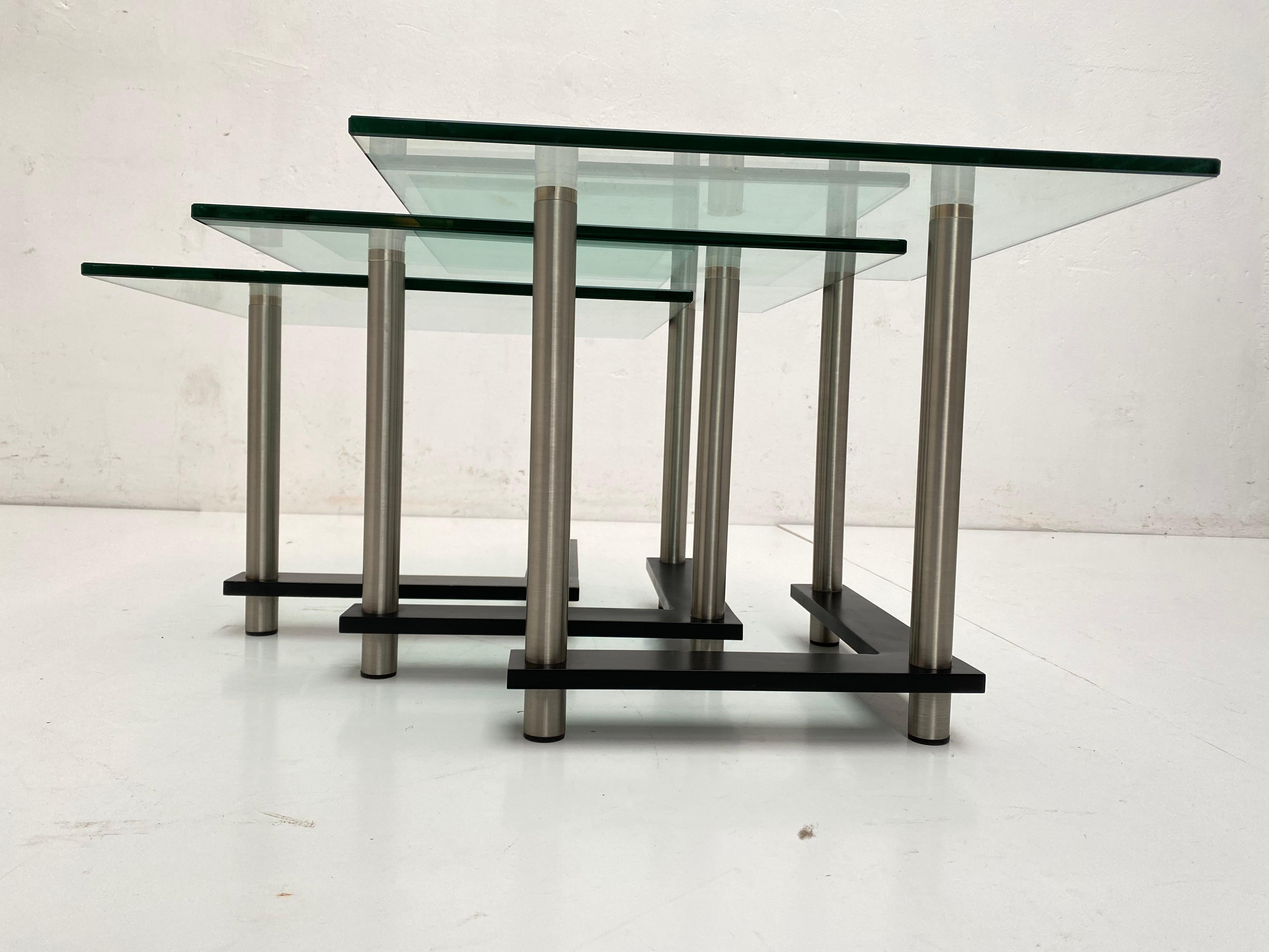 High quality production nesting tables from the 1980s with a Postmodern look

Thick tempered glass tops and stainless steel and black enameled solid metal base

Top quality production of unknown origin.