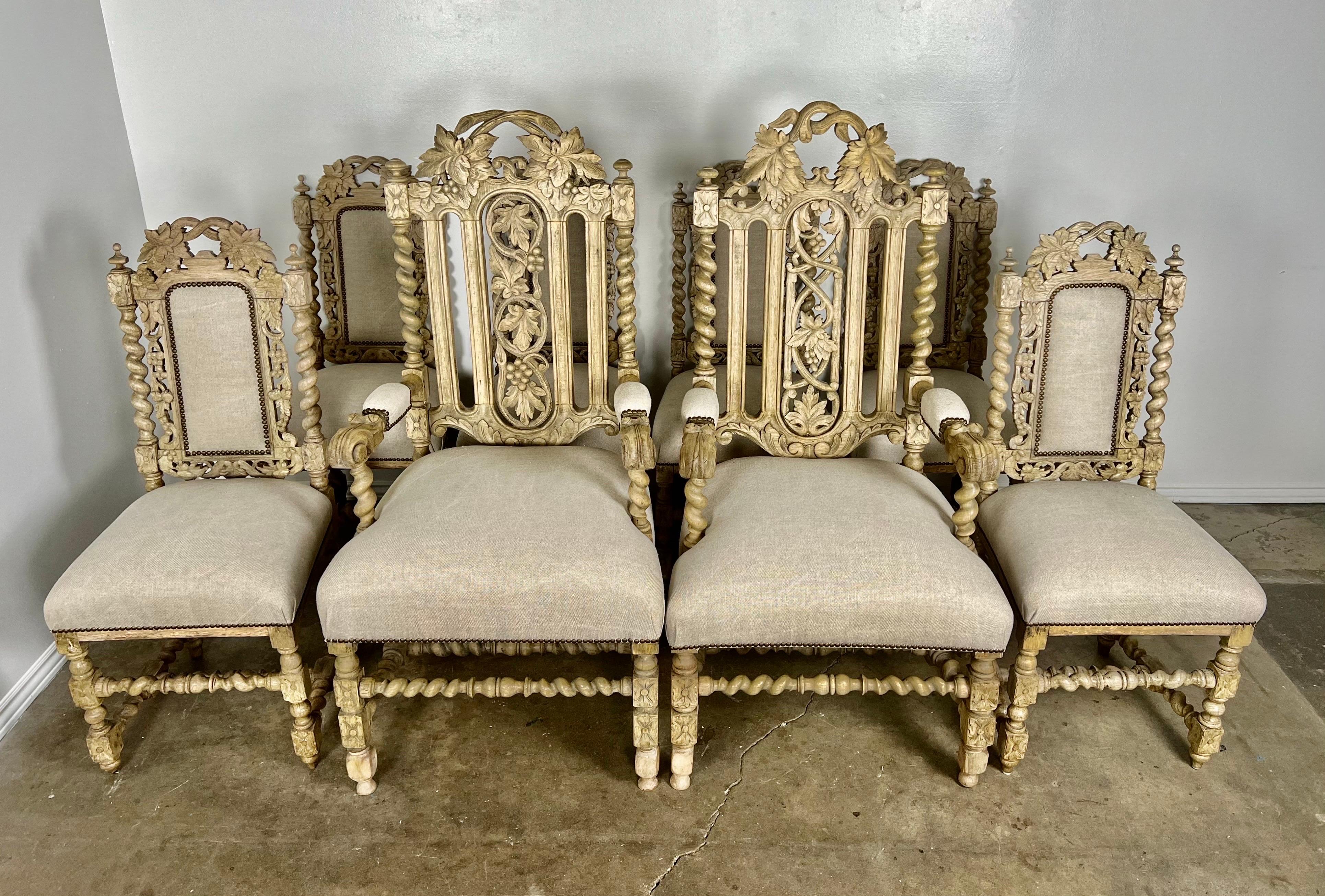 Set of 19th century English Jacobean style dining chairs. The white washed oak chairs are typical of the Jacobean style including rectangular lines combined with ample carving along the wood surfaces as well as the added decorative motifs including