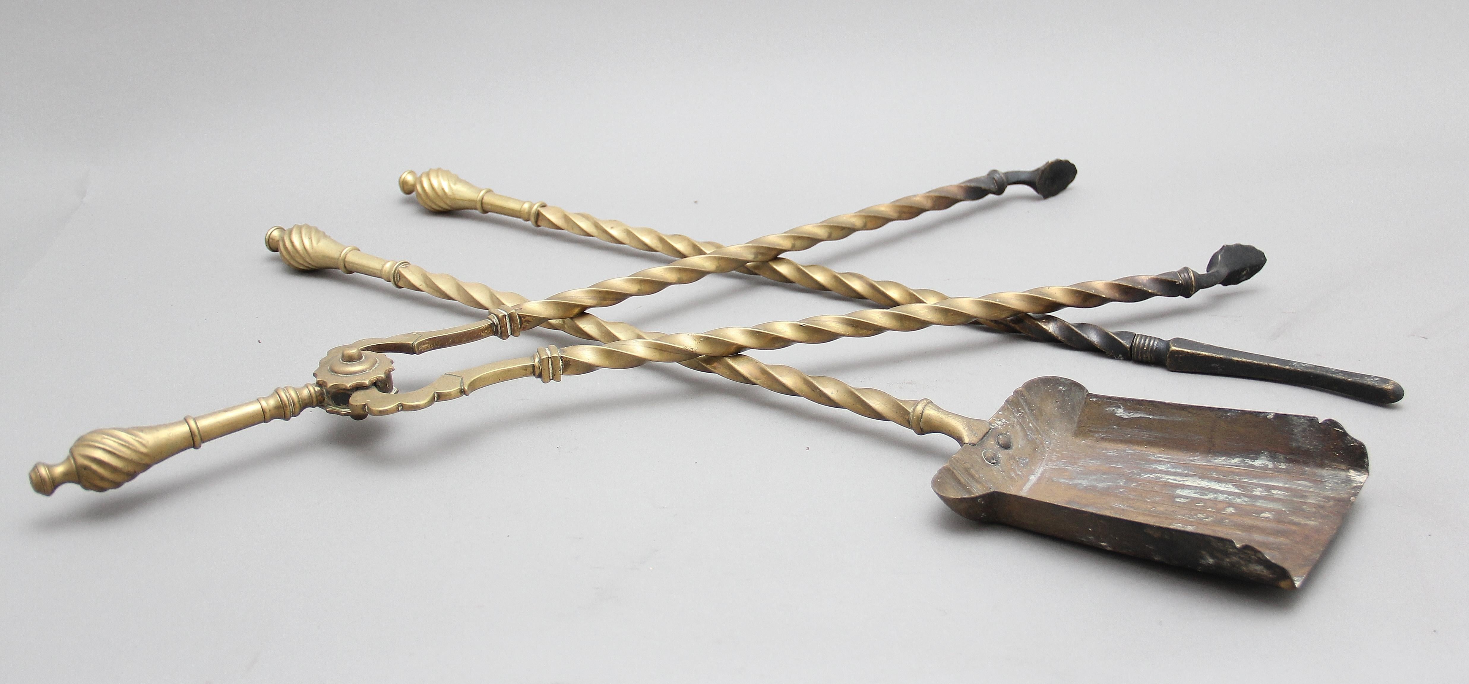 A set of three 19th Century brass fire irons of spiral design with a finial handle, the set consisting of a pair of tongs, a shovel and a poker. Circa 1860.