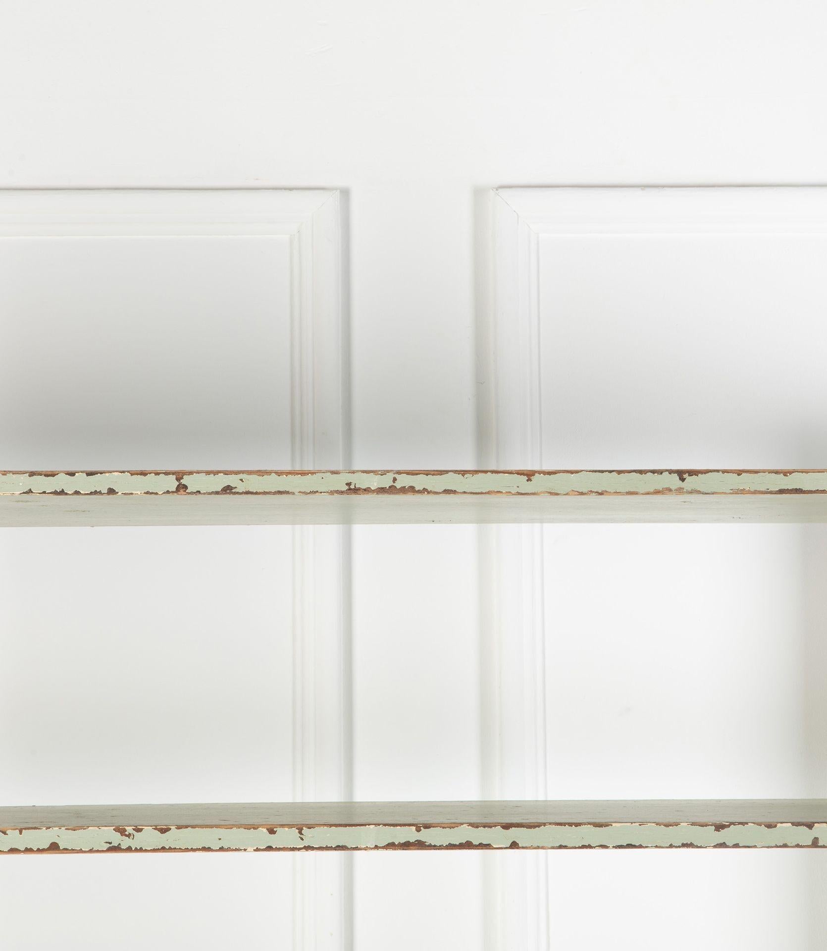Set of 19th Century English Country House kitchen shelves from a well known Wiltshire country estate.
In pitch pine with seven shelves with front pilasters topped with turned finials and finished in its original estate livery of light