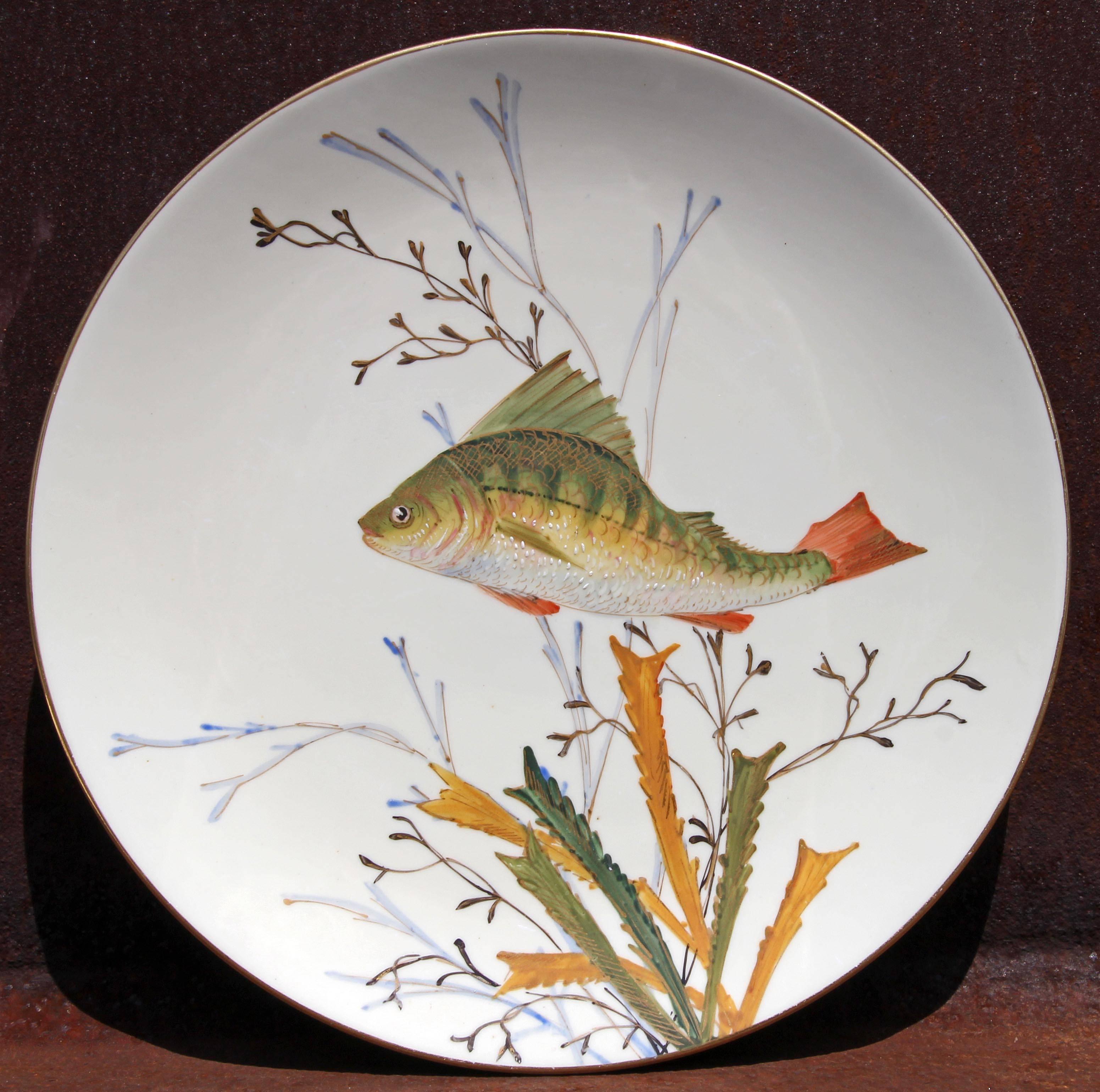Set of four antique hand painted porcelain fish plates. Marked 