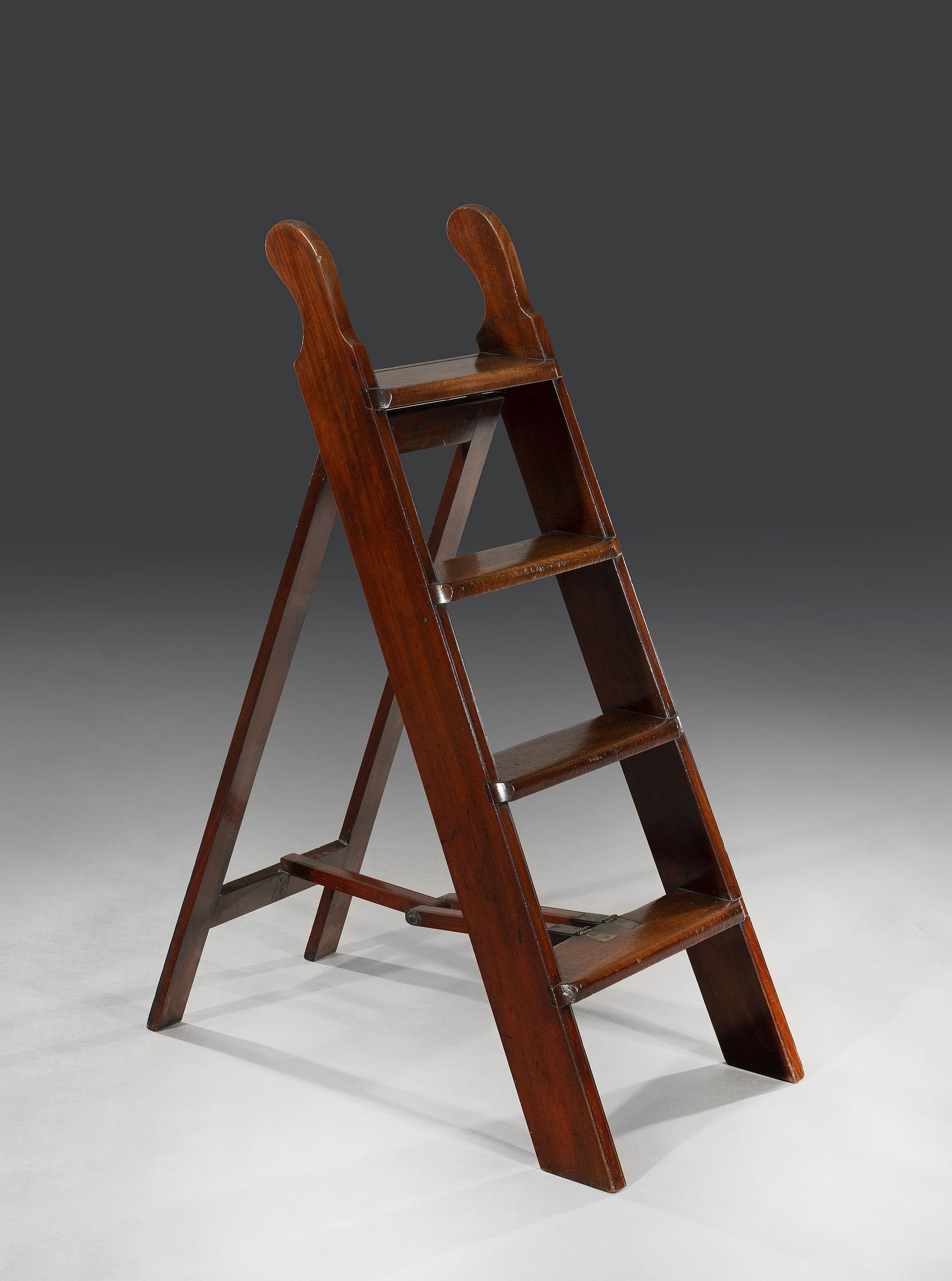 The mahogany folding library steps are in excellent condition with no breaks or splits. The steps are designed to fold flat and are hinged on gilt-brass fittings.