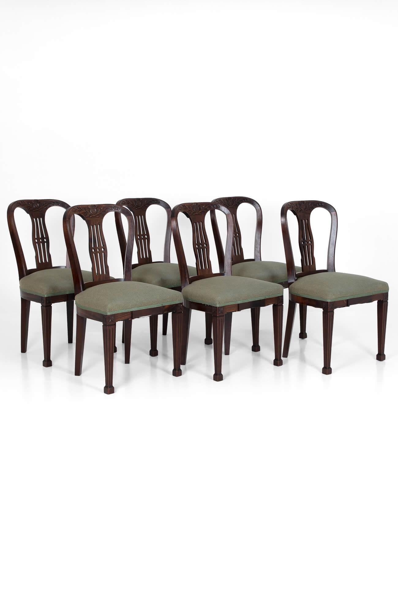 A set of six 19th century mahogany dining chairs from an English country house. In exceptional condition with classical motifs above fret cut backs and tapered legs on square feet. Fully restored with new calico and webbing, with seats reupholstered