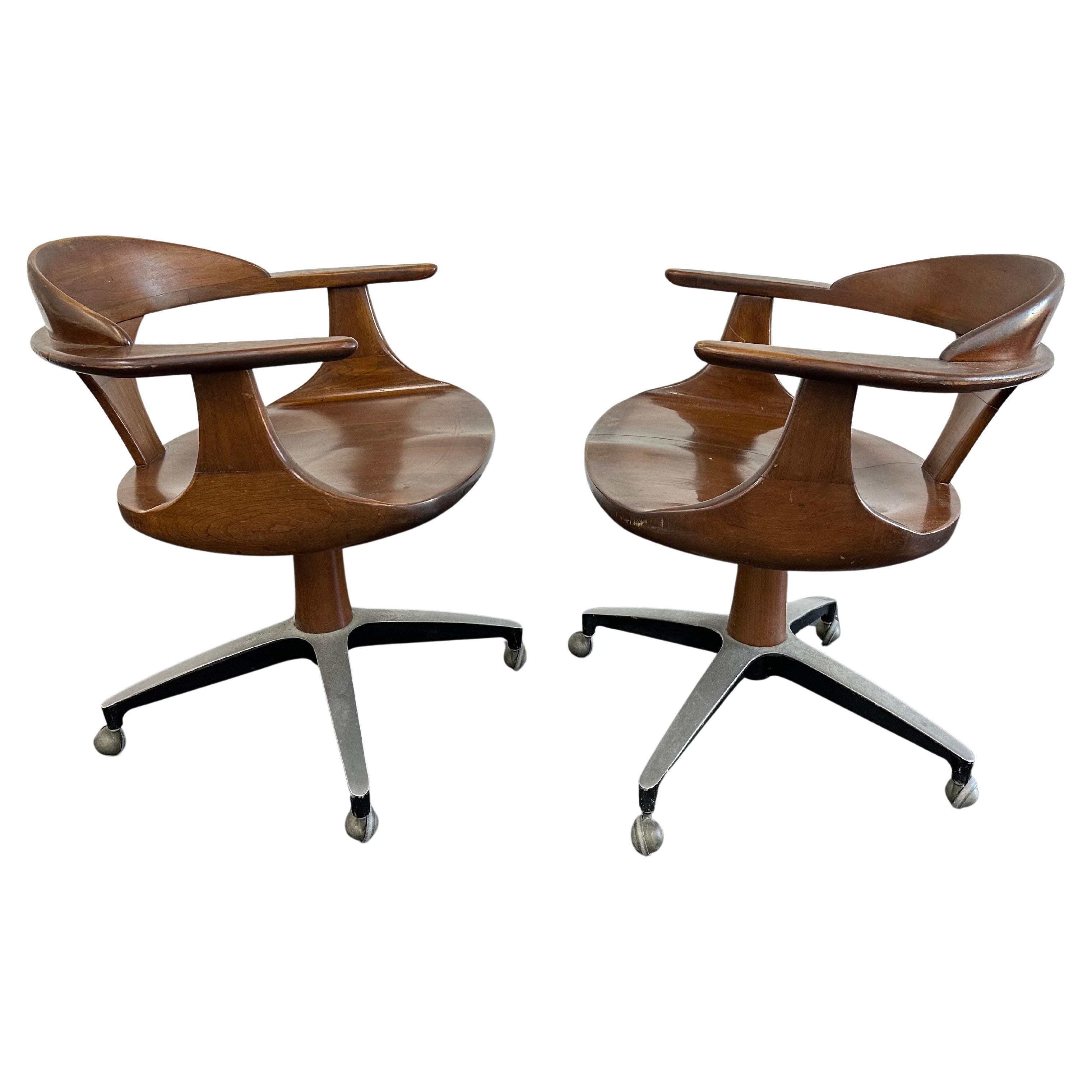 Set of 2 Cliff House chairs by Heywood Wakefield c.1960s. Sculpted cherry hardwood with a brown doeskin finish and curved steel bases with casters. An uncommon set part of the Cliff House collection manufactured in 1964 and 1965. Price is for the