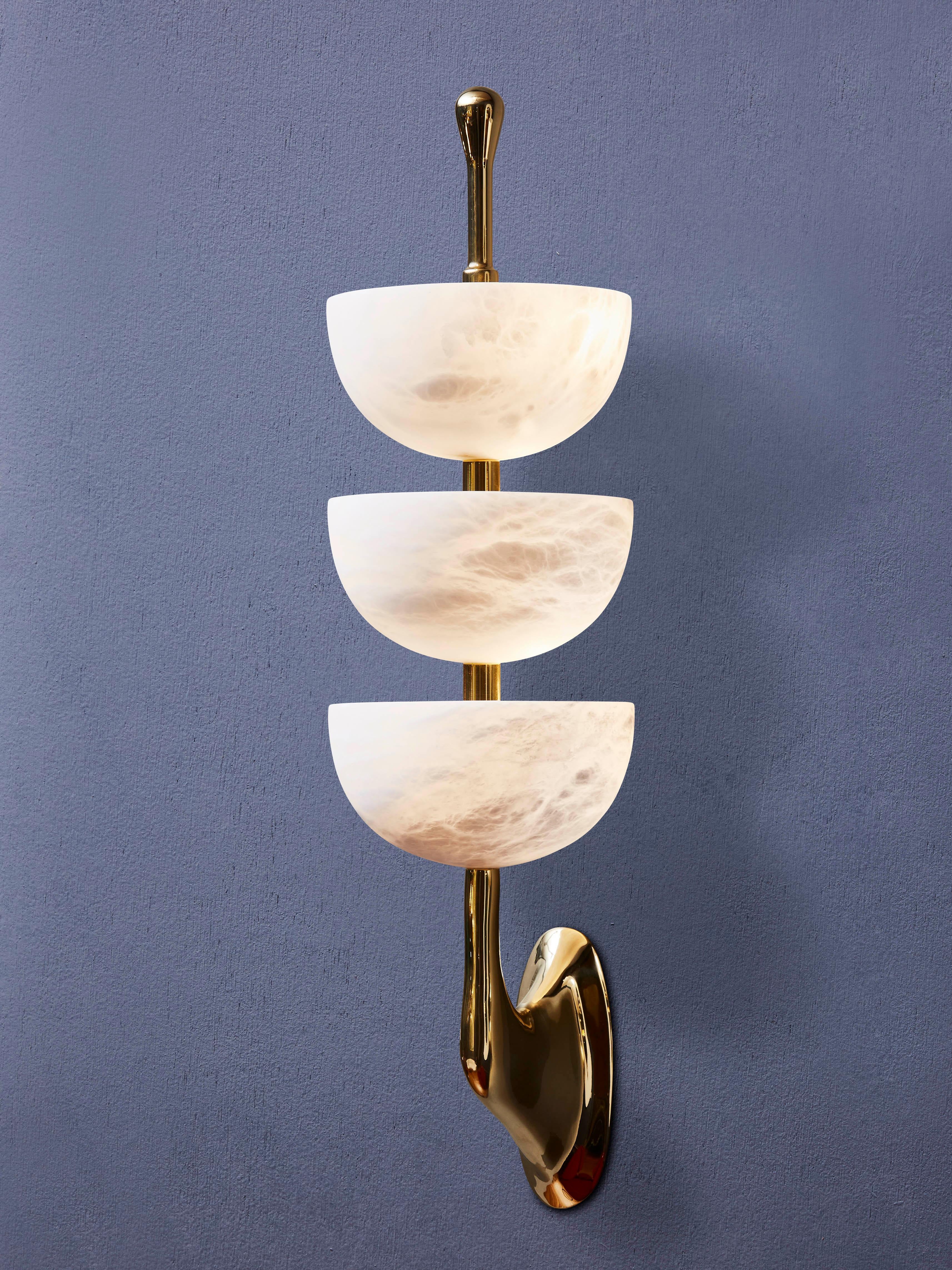 Pair of wall lights in polished brass and enlightened alabaster cups.
France, 2023.