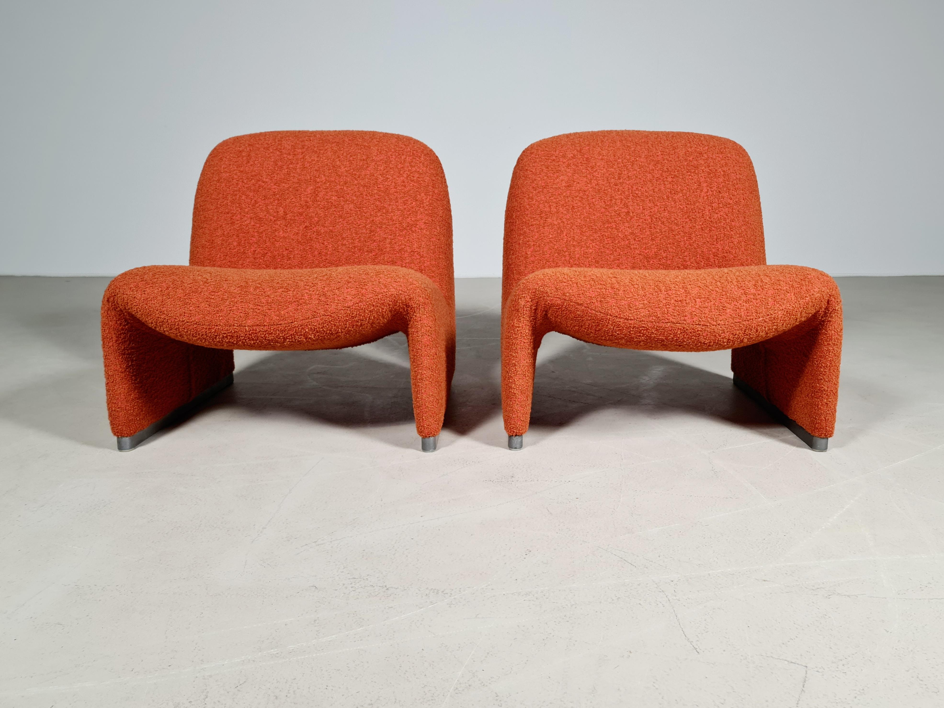 Giancarlo Piretti designed lounge “Alky” chairs newly upholstered in a high-end rusty red/orange cotton/wool Bouclé. Aluminum frame and polished chrome foot rests. Beautiful organic curves reminiscent of Pierre Paulin designs. Produced by Castelli 