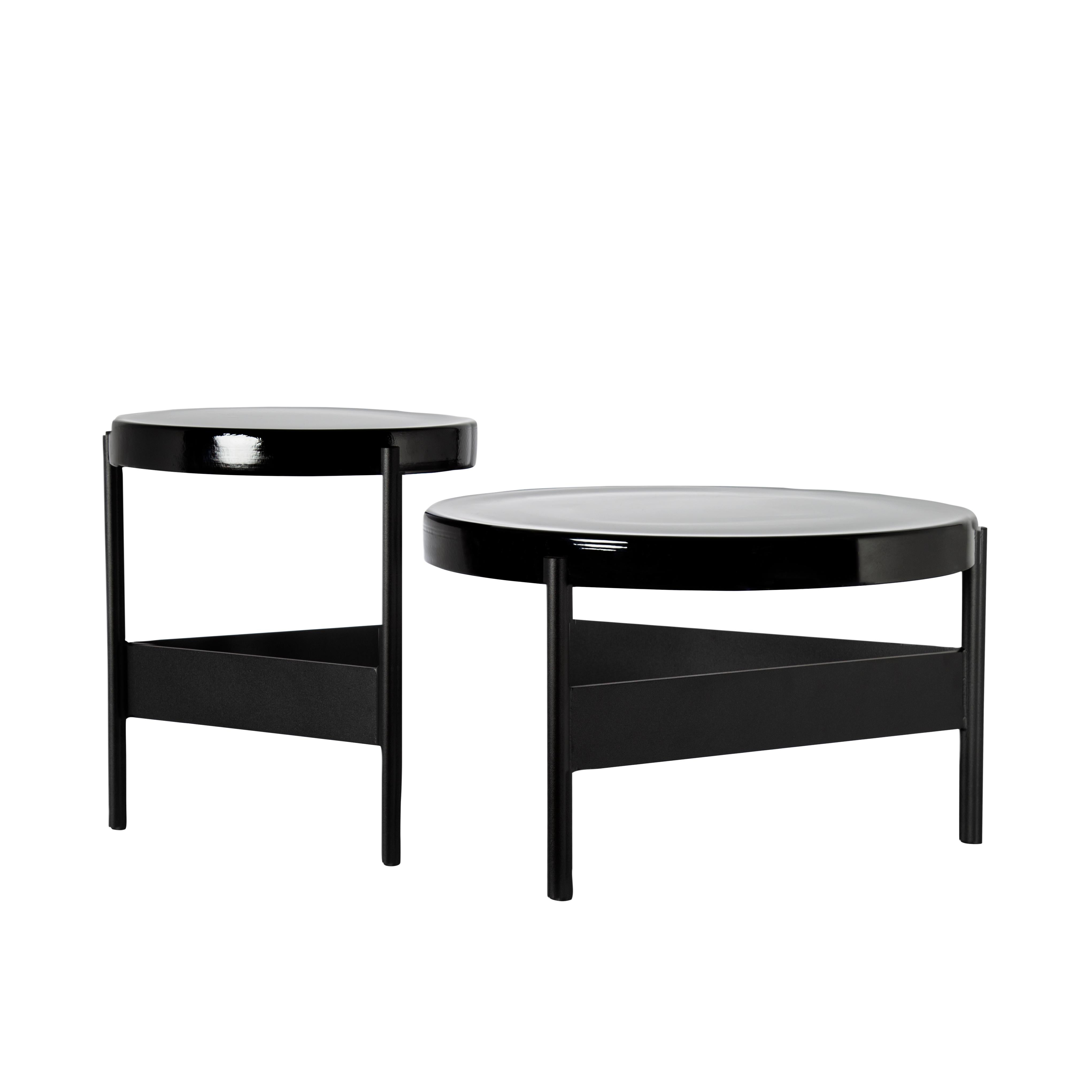 Set of 2 Alwa two tables by Pulpo.
Dimensions: D56 x H35 cm // D 38 x H 44 cm.
Materials: casted glass; powder coated steel 

Also available in different finishes.

Normally, glass is regarded as being lightweight with sharp edges. In