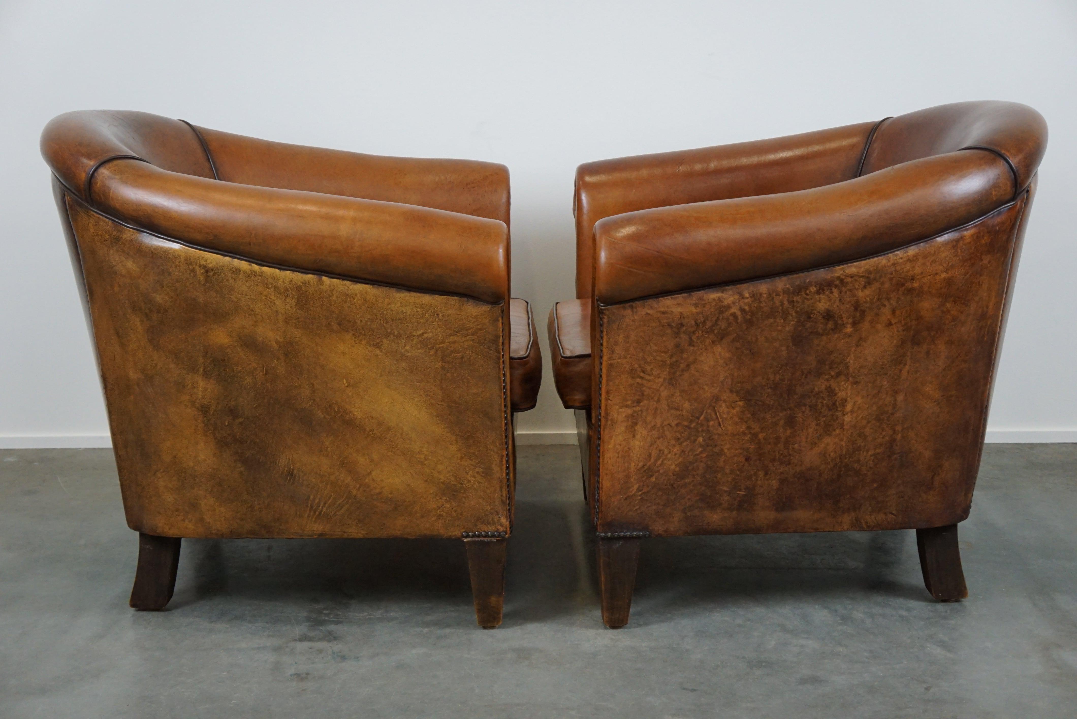 Sheep leather club armchairs are already a beloved item on their own, but as a set of two, they're even more desirable. This highly sought-after set has a comfortable seat and a beautiful appearance, just as enthusiasts like to see them. Apart from