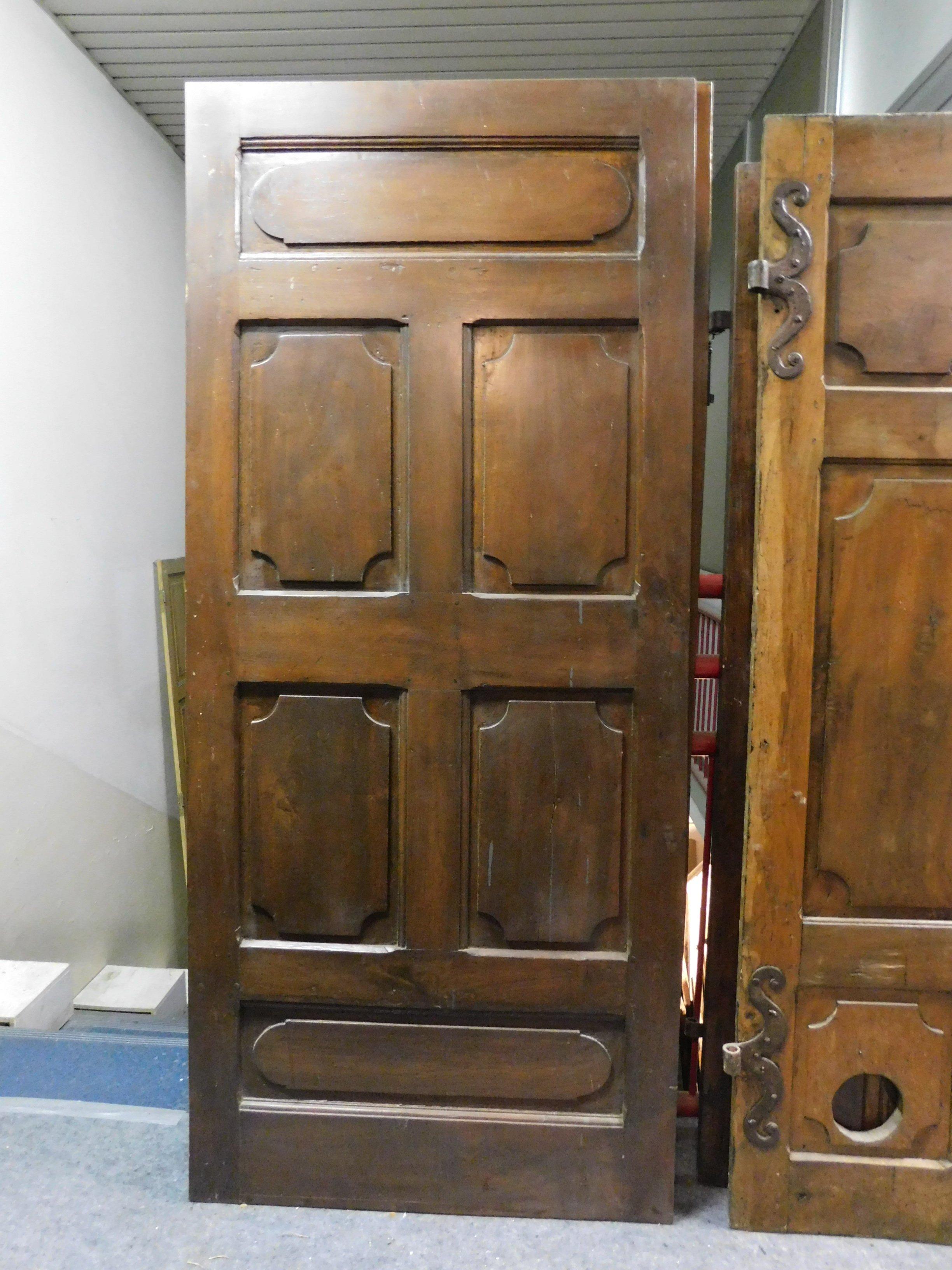 Set of 2 antique doors, handmade in precious walnut, dark brown solid wood typical of very hard wood, hand carved panels, and in very good condition, still with original irons, made in Italy in the 18th century.
2 sold separately, but exceptional