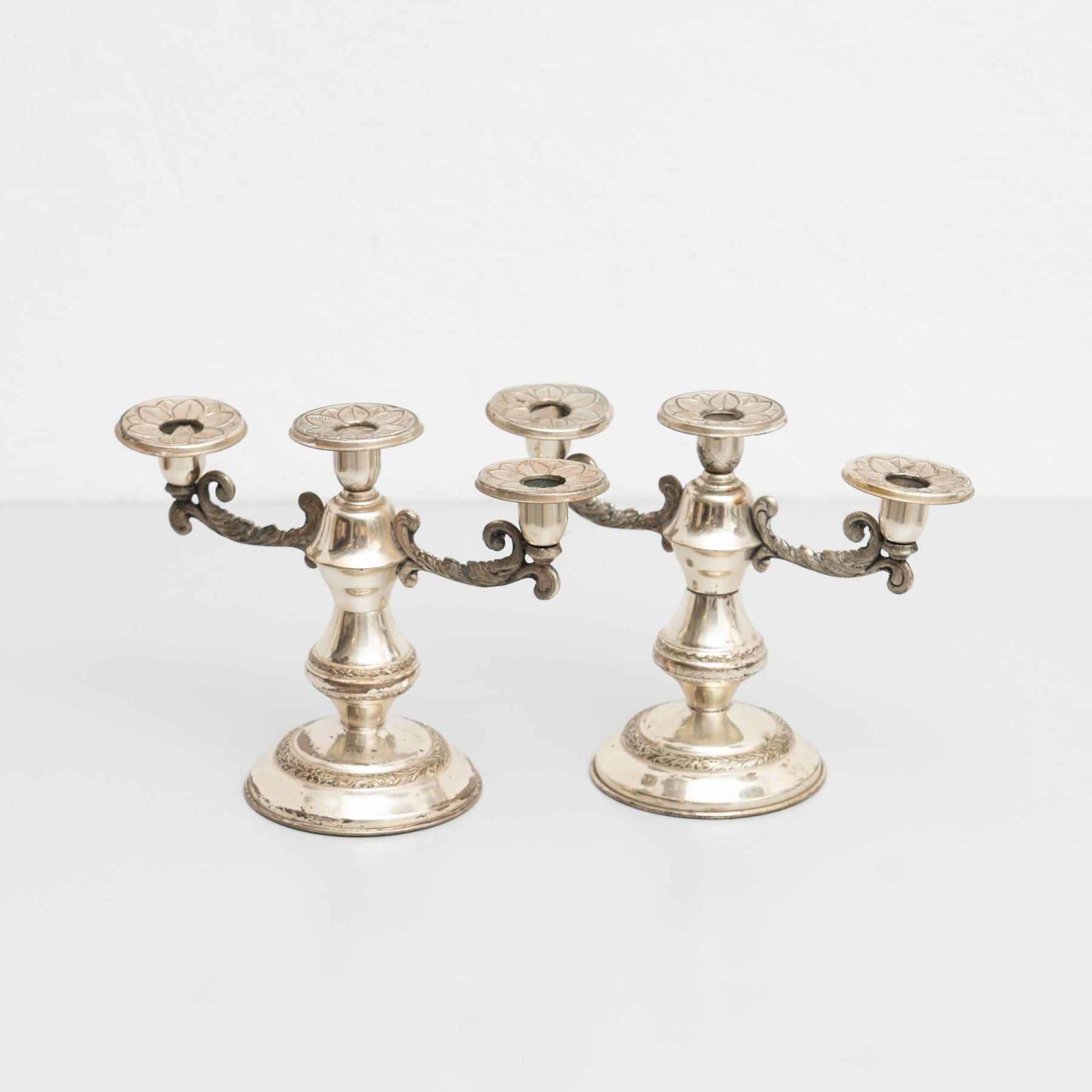 Set of 2 antique metal candle holders, circa 1950
By unknown manufacturer. Spain

In original condition, with minor wear consistent with age and use, preserving a beautiful patina.
  
Material:
Metal.

