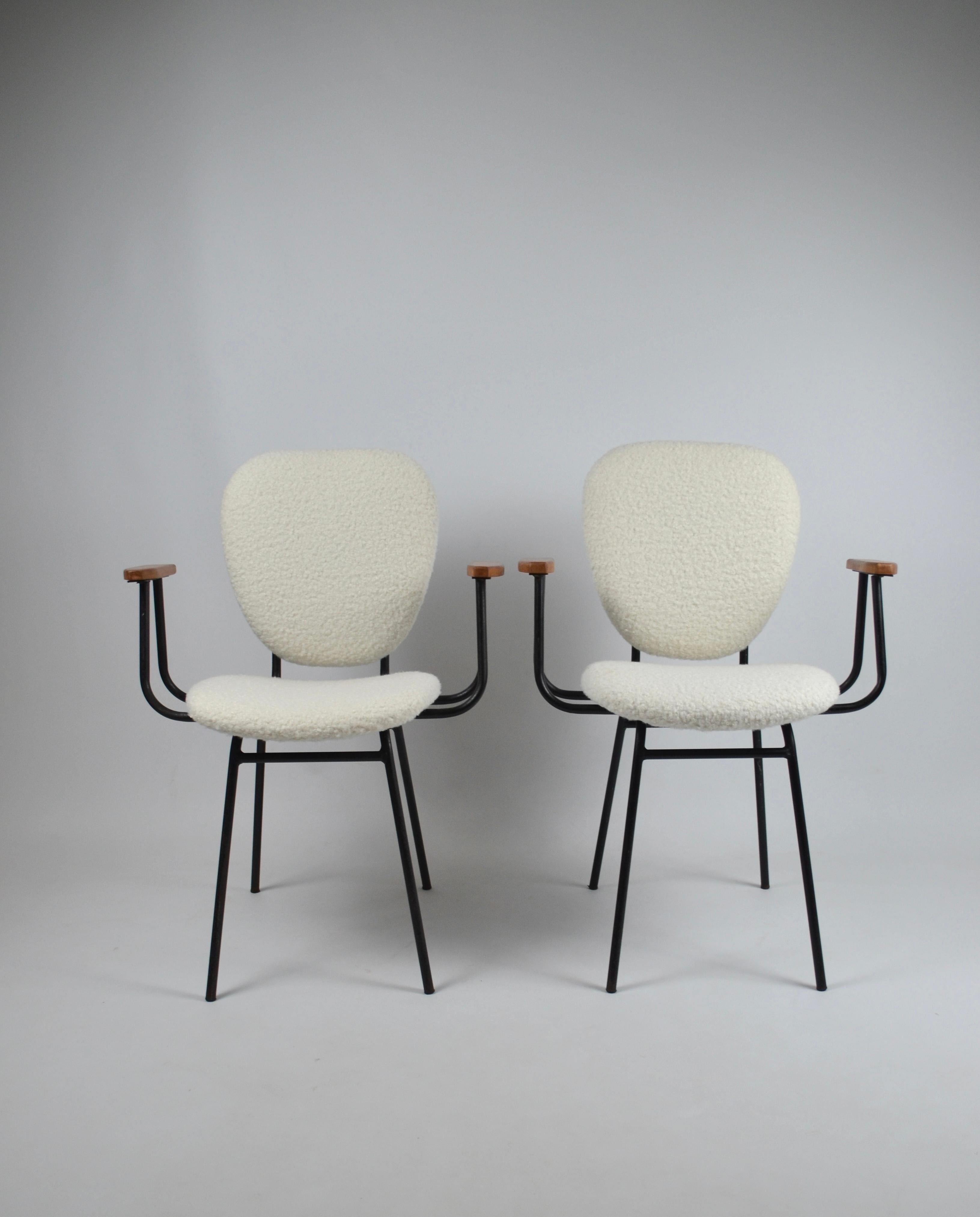 Pair of armchairs by french designer Jacques Hitier produced by Tubauto, 1950s, France. 
They consist of two wooden armrests and a black lacquered metal base (original paint which may show slight signs of wear). They have been reupholstered in a