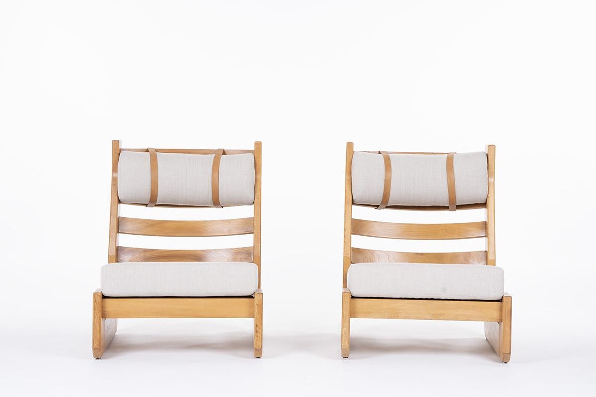 Set of 2 low chairs by Maison Regain in the 1980s.
Structure entirely in elm, cushions for the seat and back in foam covered with linen.
Leather straps to complete the set.