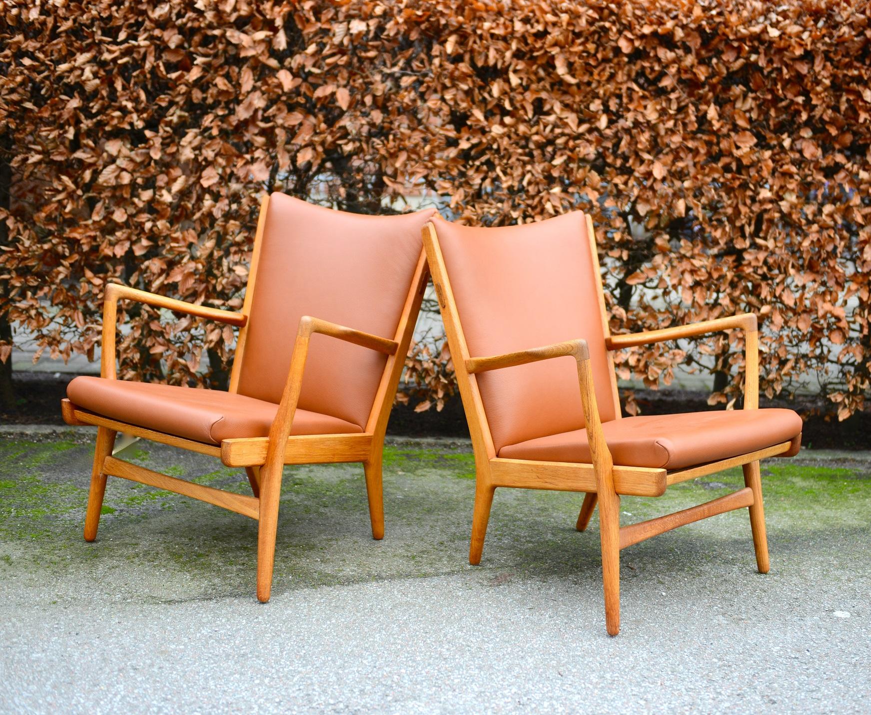 Set of 2 armchairs model AP-16 made of oak and newly re-upholstered in soft leather. Designed by Danish designer Hans J. Wegner in the 1950s. Produced by furniture maker A.P. Stolen in Denmark. Midcentury Scandinavian modern design by one of the