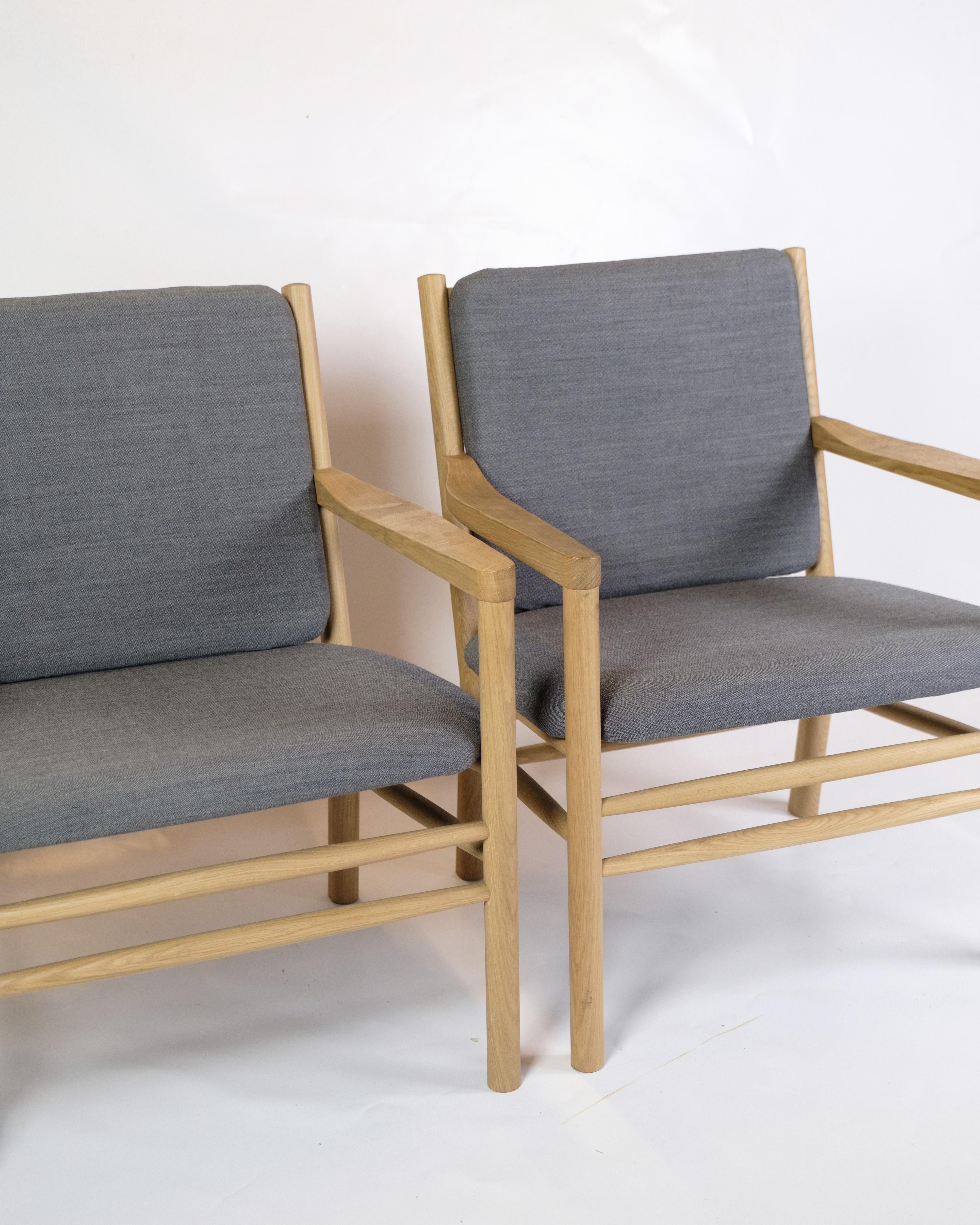 This set of two armchairs, model J147, exudes a sublime combination of comfort and elegance. Made from solid oak and upholstered in a stylish gray wool cover, these armchairs offer a luxurious seating experience.

Erik Ole Jørgensen, a renowned