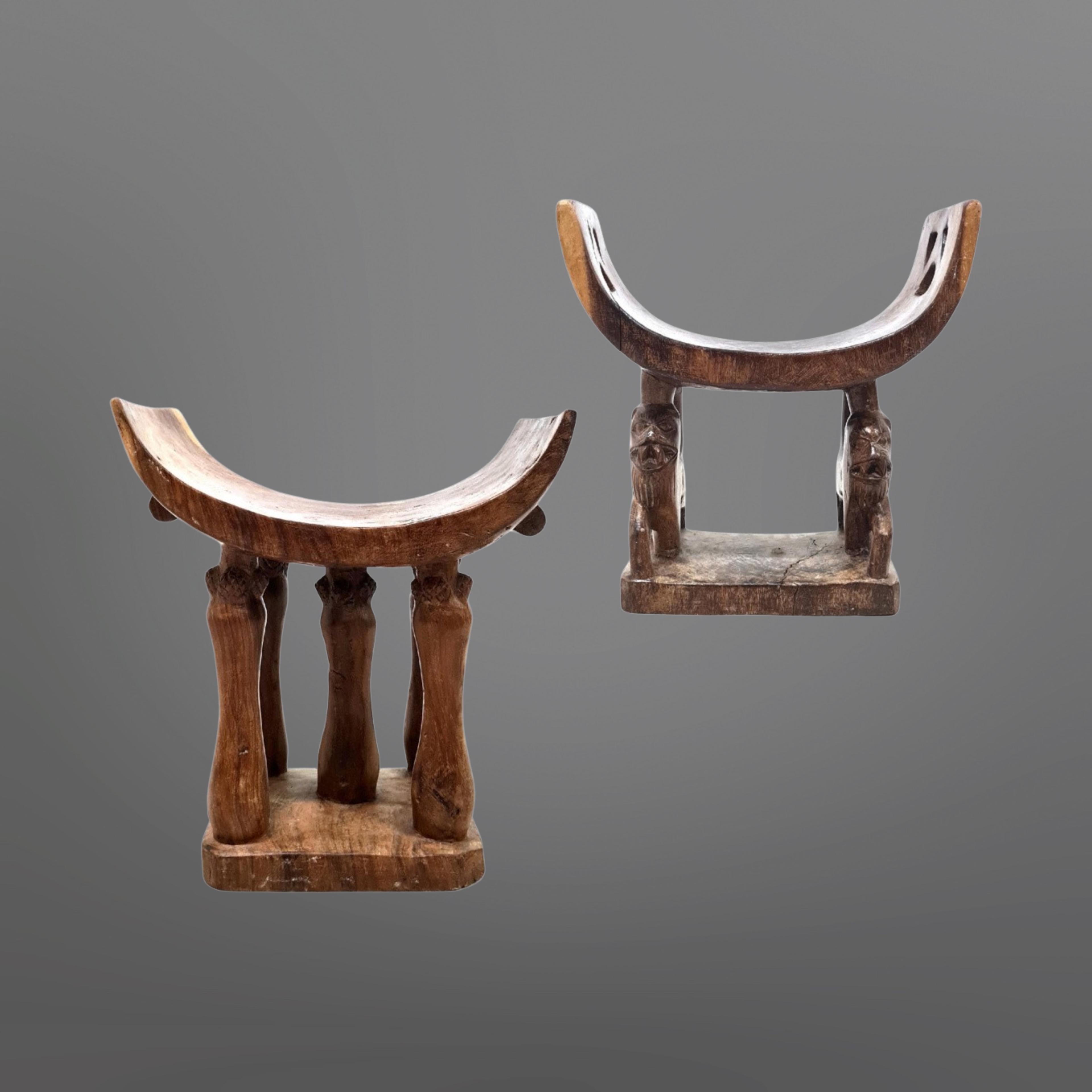 Set of two hardwood stools. Hand carved by the Asante or Ashanti tribe of Ghana. Attractive sculptural pieces with beautiful woodgrain and natural colors. Both stools are in very good condition. They show natural occurring cracks and imperfections