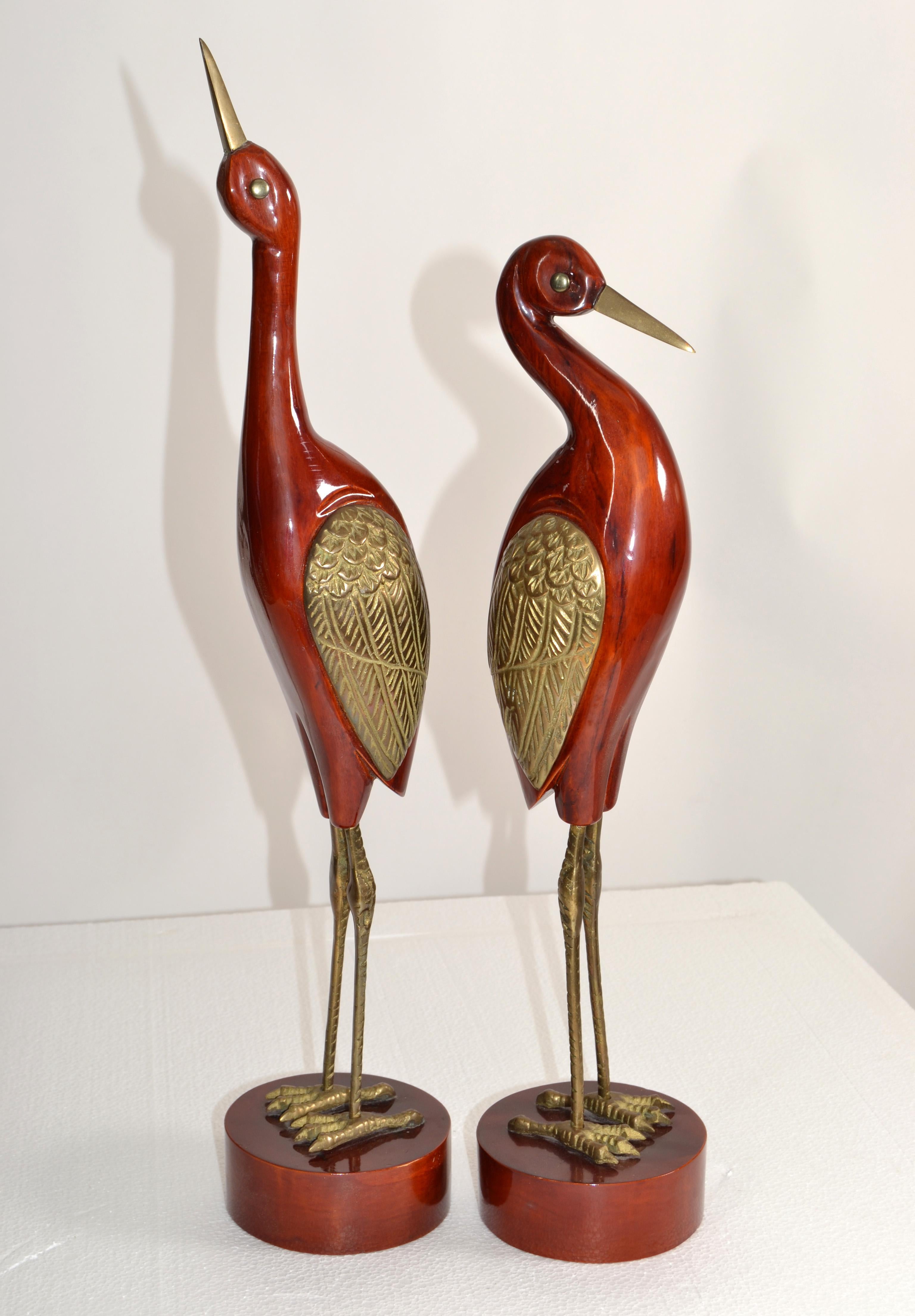 A Pair of vintage Brass Asian inspired Crane Sculptures on round hardwood bases.
Marked underneath Made in Korea.
Cranes have been used throughout design for ages because of their unique form and are considered lucky in Asia.
Smaller Crane is 18
