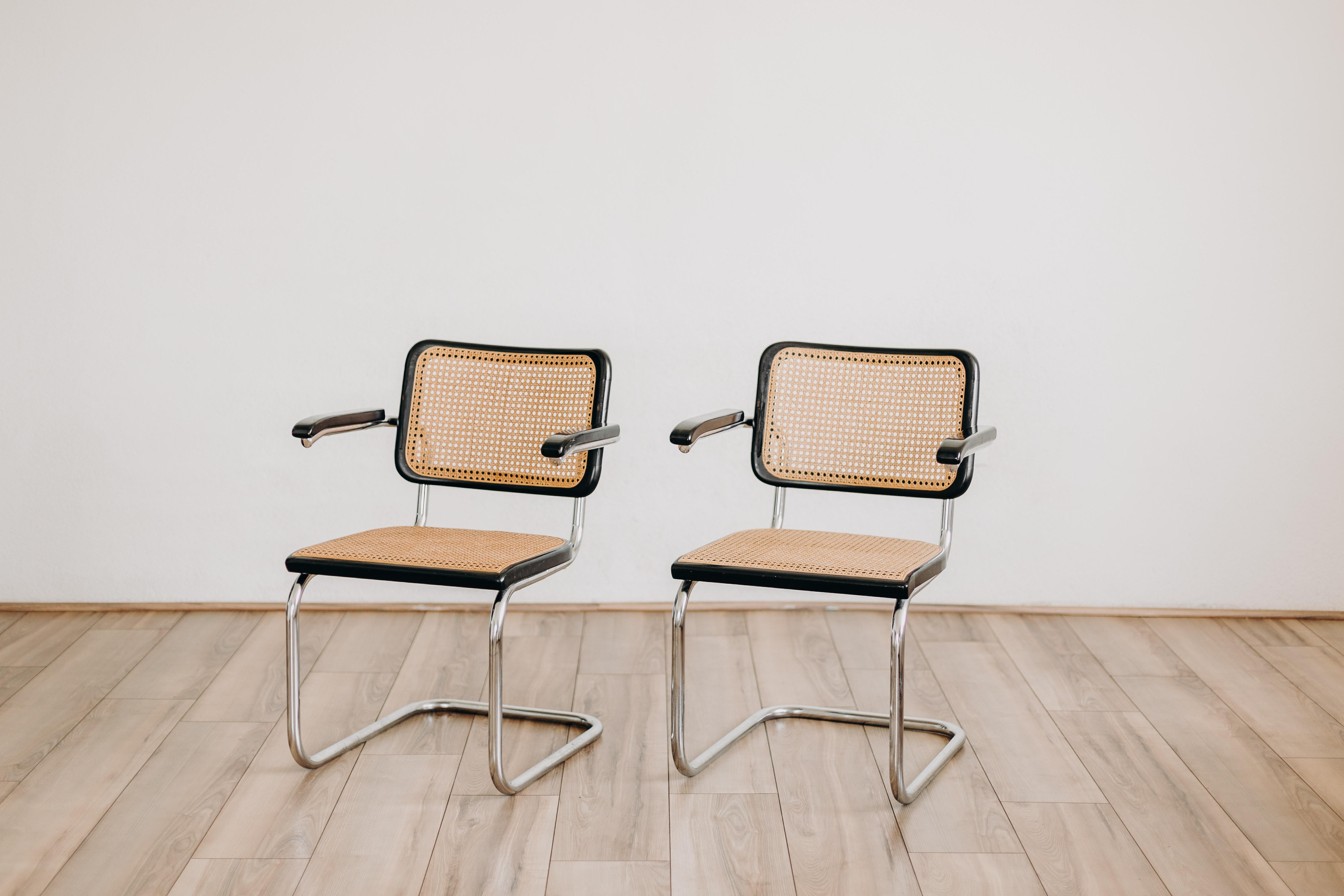 This set of two armchairs, the Cesca B64 model, is an iconic design by the renowned architect and designer Marcel Breuer. Originally designed in the 1930s, these chairs were later re-edited by Thonet in the 1970s, making them a rare and coveted