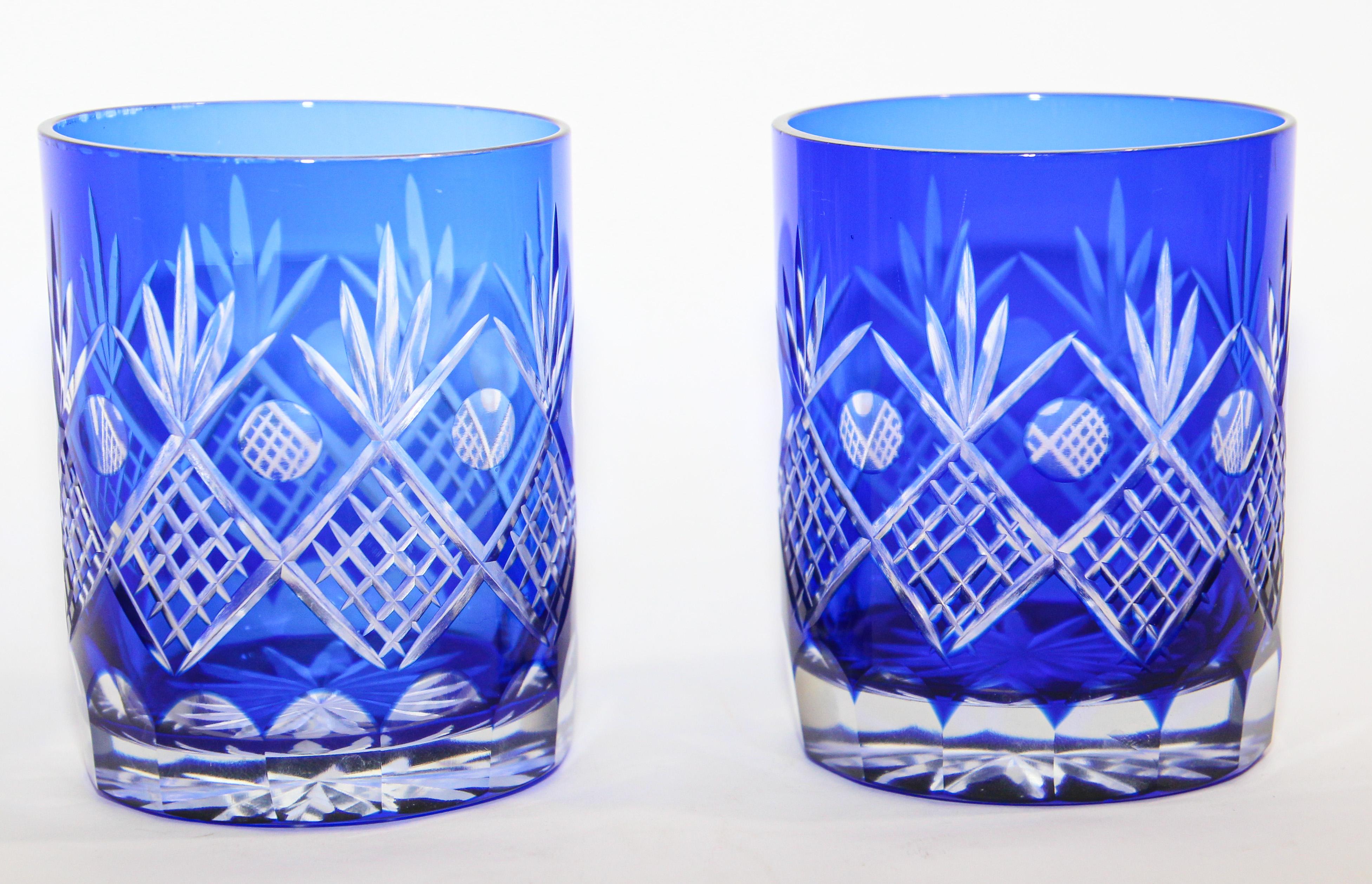 Set of 2 vintage whiskey glasses tumbler cobalt blue crystal Baccarat style. 
The vibrant hand blown rich sapphire blue jewel sapphire blue crystal glass is cut to clear to reveal a lovely pattern with clean lines. 
Set of rock whiskey juice or