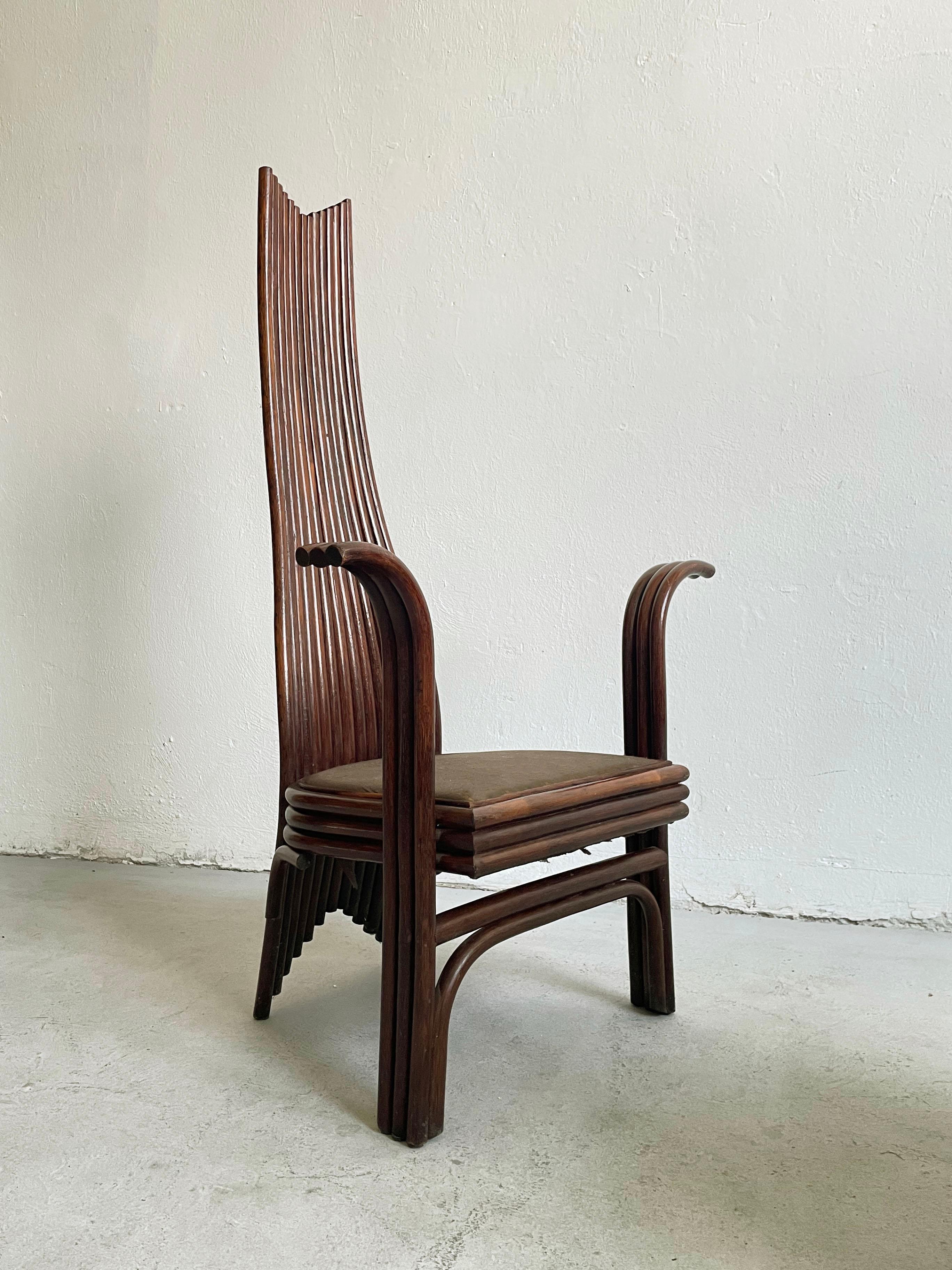 Set of two extravagant dining chairs designed and produced by Mcguire in the USA in the 1980s. 

This design is often attributed to Danny Ho Fong. 

The chairs are constructed of dark brown stained bamboo, and have a very high curved back and