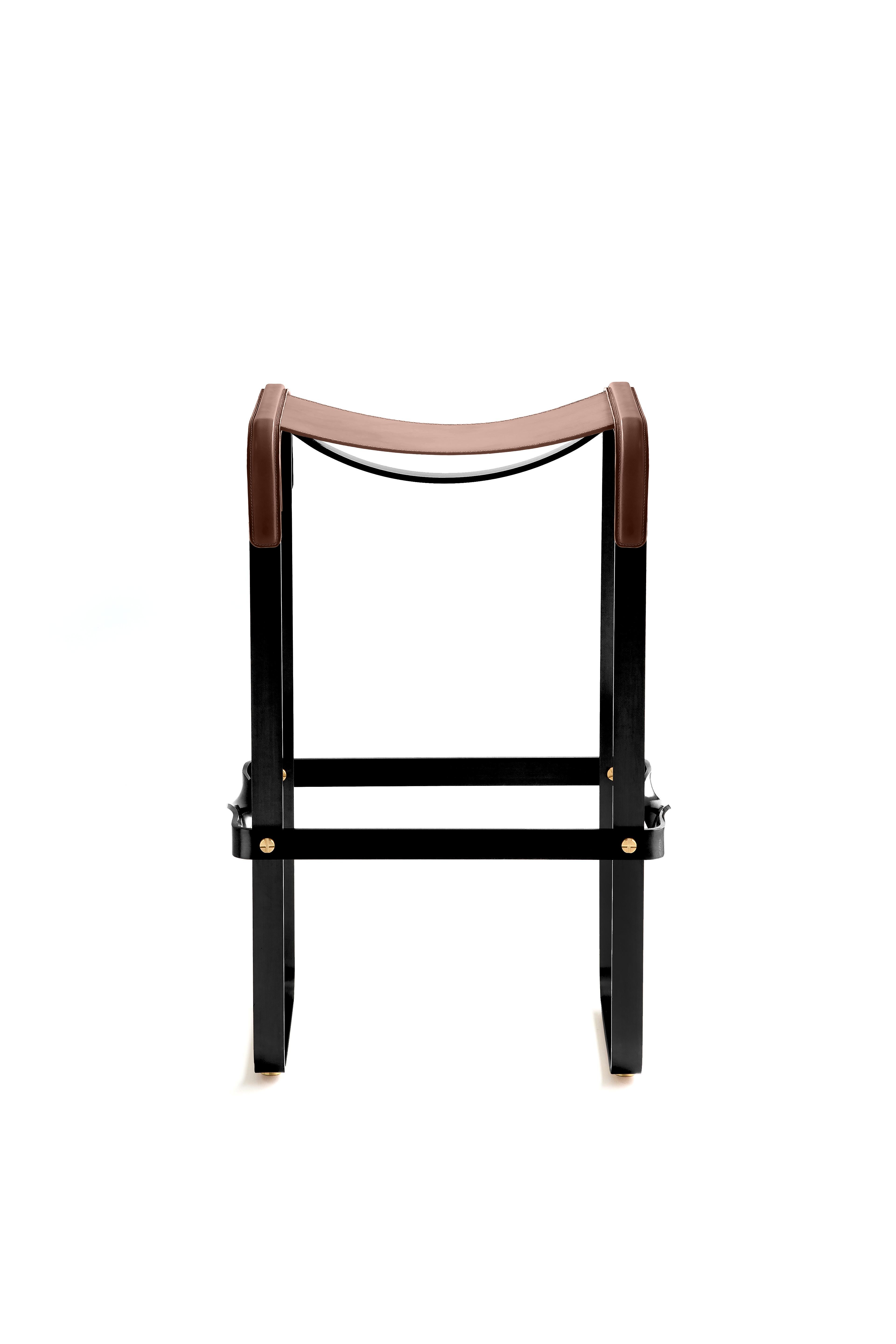 The Wanderlust contemporary barstool belongs to a collection of Minimalist and serene pieces where exclusivity and precision are shown in small details such as the hand-turned metal nuts and bolts that fix the leather surfaces, that go unnoticed at