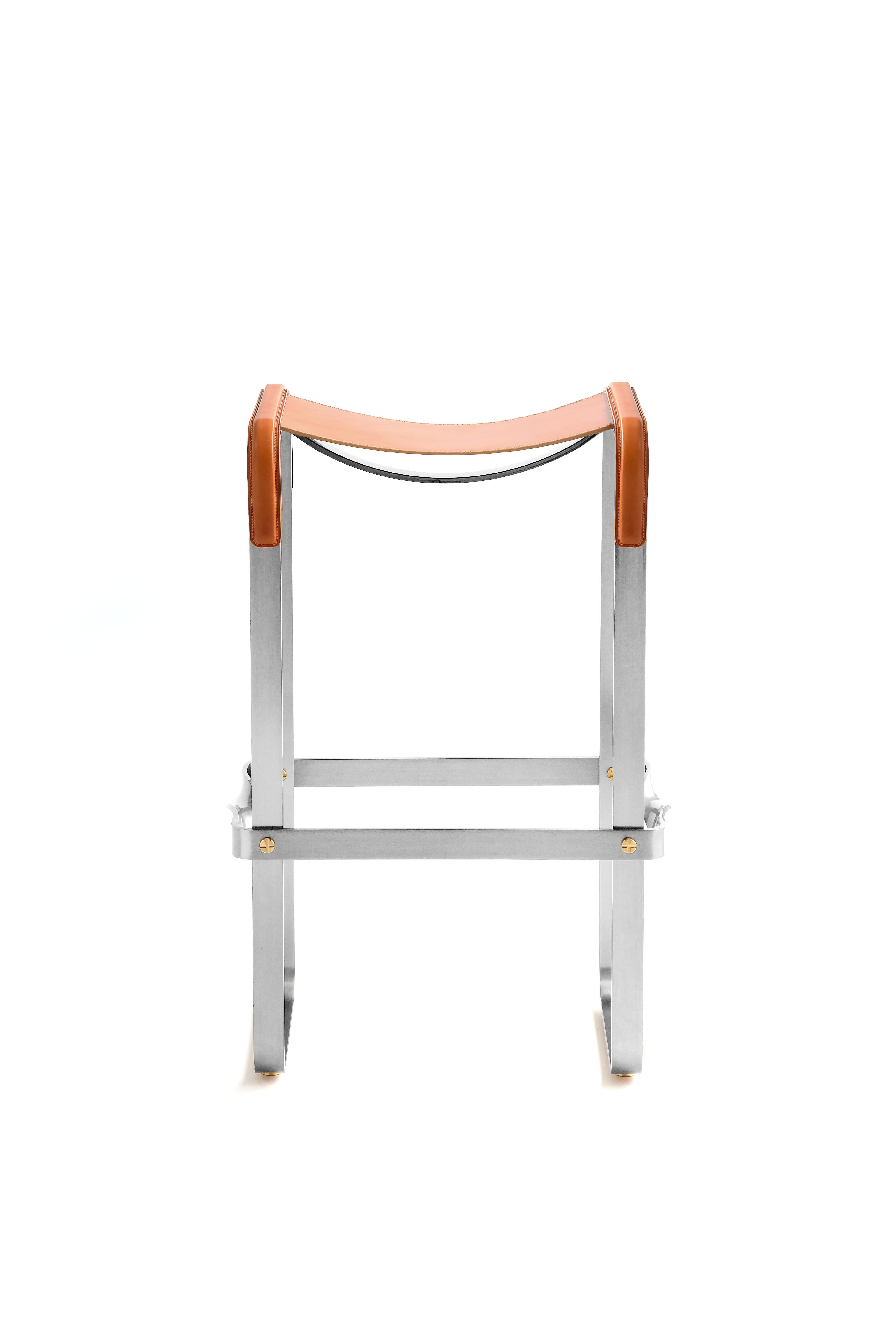 The Wanderlust contemporary barstool belongs to a collection of minimalist and serene pieces where exclusivity and precision are shown in small details such as the hand-turned metal nuts and bolts that fix the leather surfaces, that go unnoticed at