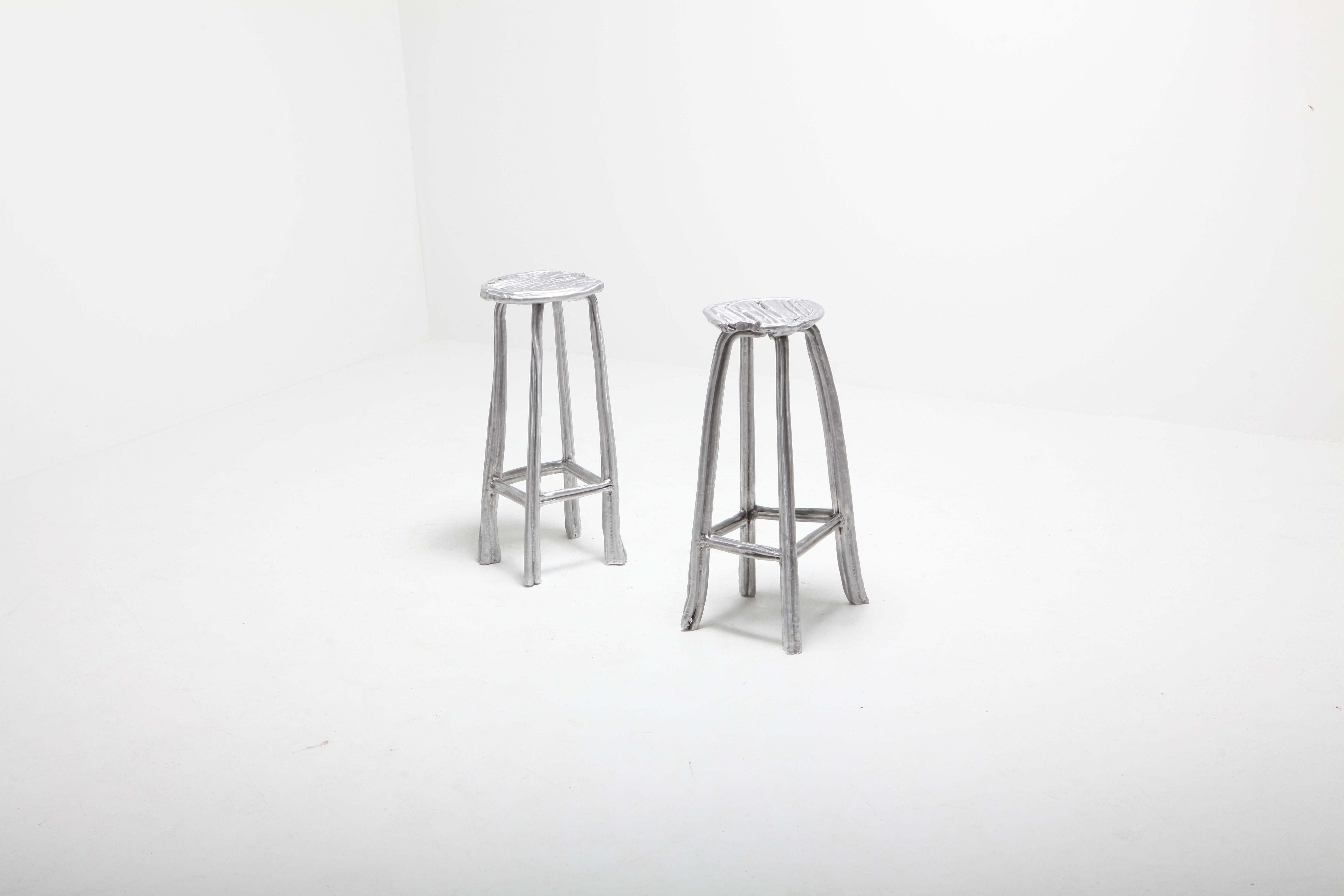 Set Of 2 Bar Stools by Studio Nicolas Erauw
Unique piece. Limited Edition 1 of 1.

Dimensions: 
- H 70 cm x Ø 33 cm
- H 70 cmx Ø 35 cm

Materials: Aluminum, wax dipped

Part of the on-going ‘Wax on/Wax off series’. These series are a collection of
