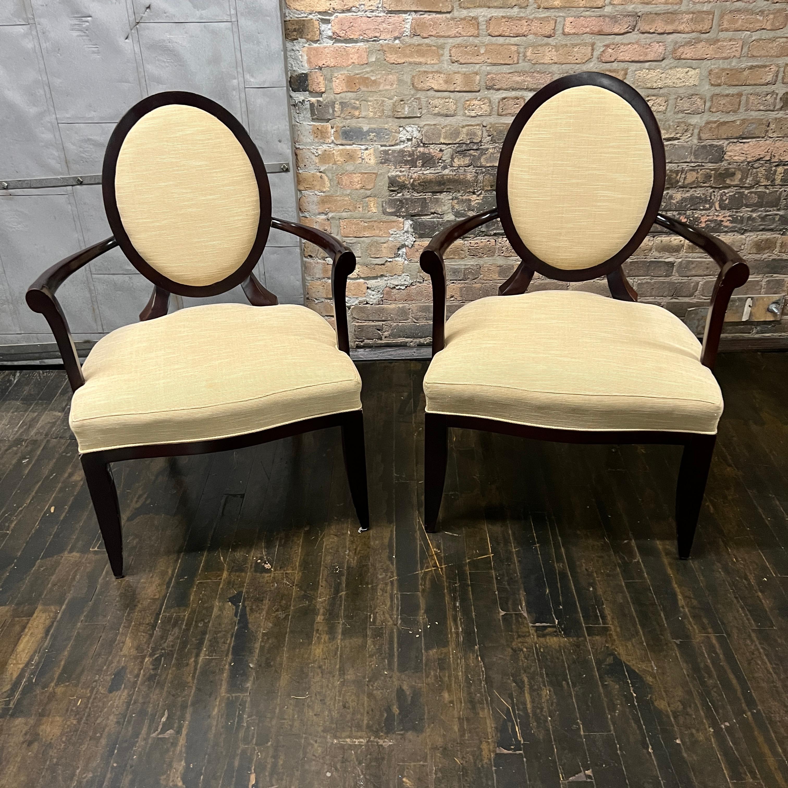 A set of 2 X back dining chairs with arms designed by Barbara Barry for Baker.  These chairs are still in production today (and sell for between $3K - $4K per chair). These are super solid, highly quality dining chairs. 

The upholstery is tan in