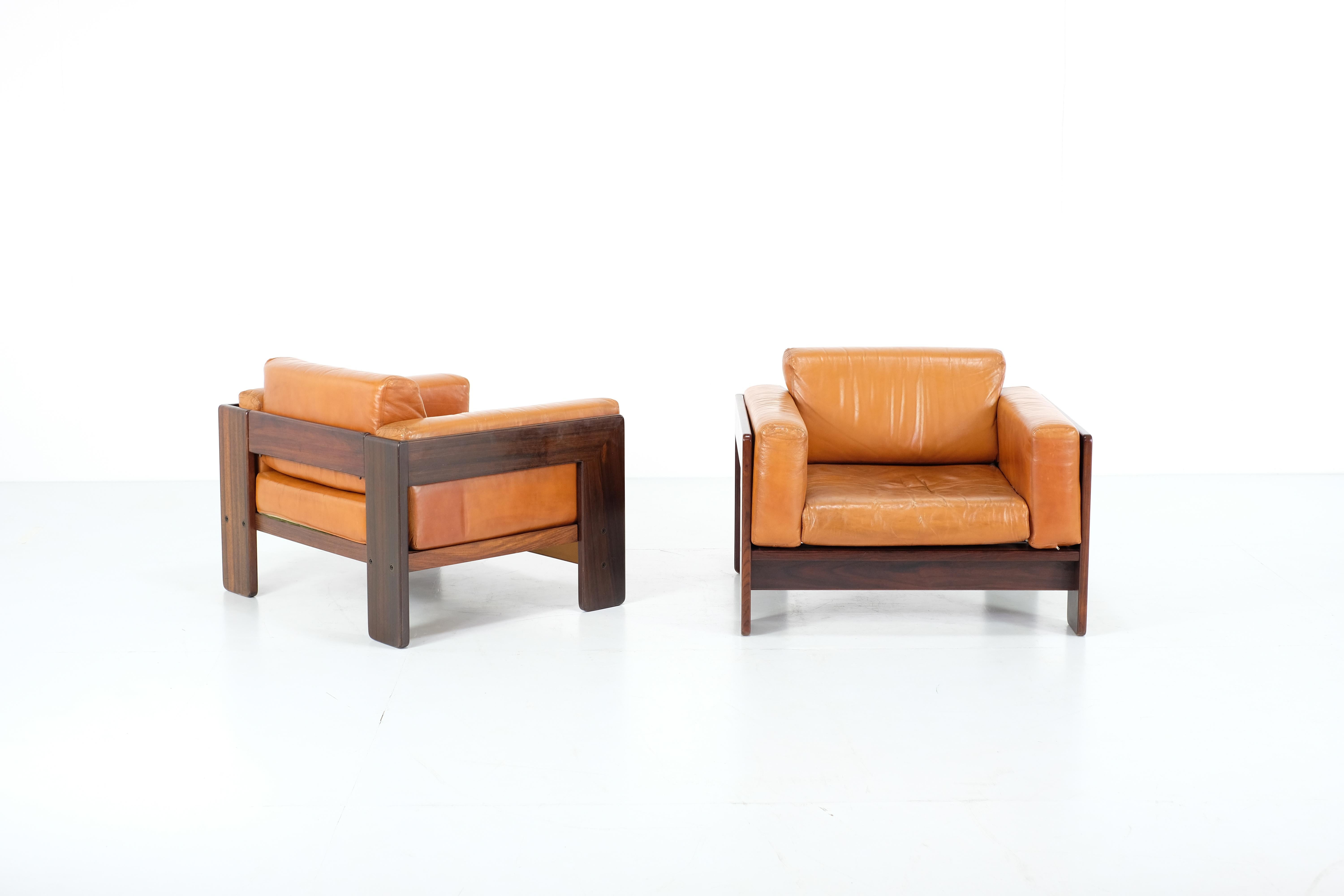 Amazing pair of Bastiano leather armchairs by Afra and Tobia Scarpa for Gavina, in the 1960s. 
wooden structure with original cognac leather seats
 (the leather of the seats have been restored). 
they show signs of wear due to time but in really