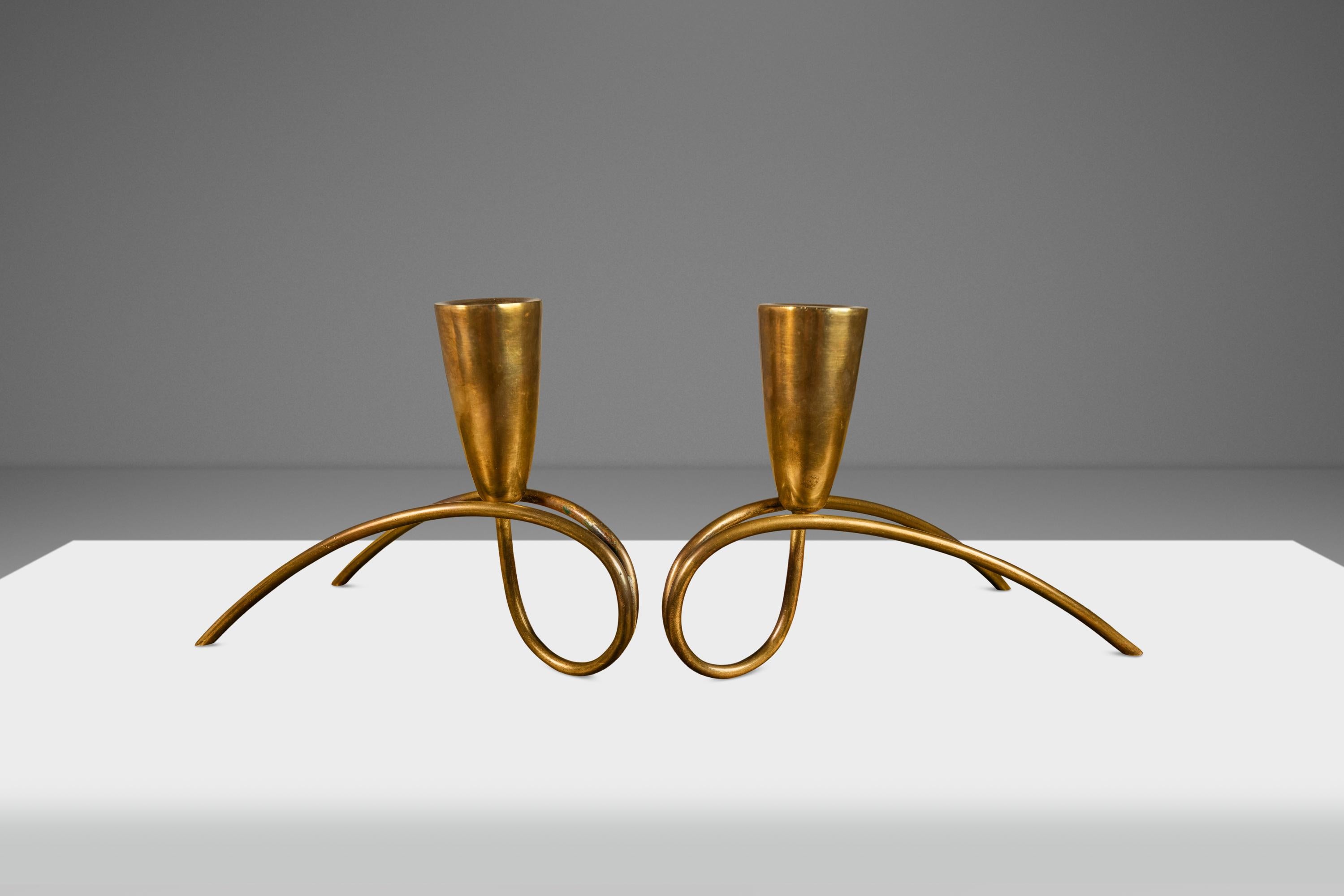Introducing a gorgeous set of Bauhaus candlestick holders forged from solid brass and bent into a these fantastic shapes. Attributed to the renowned Günter Kupetz, a German-born industrial designer, this set of candlestick holders is ideal for