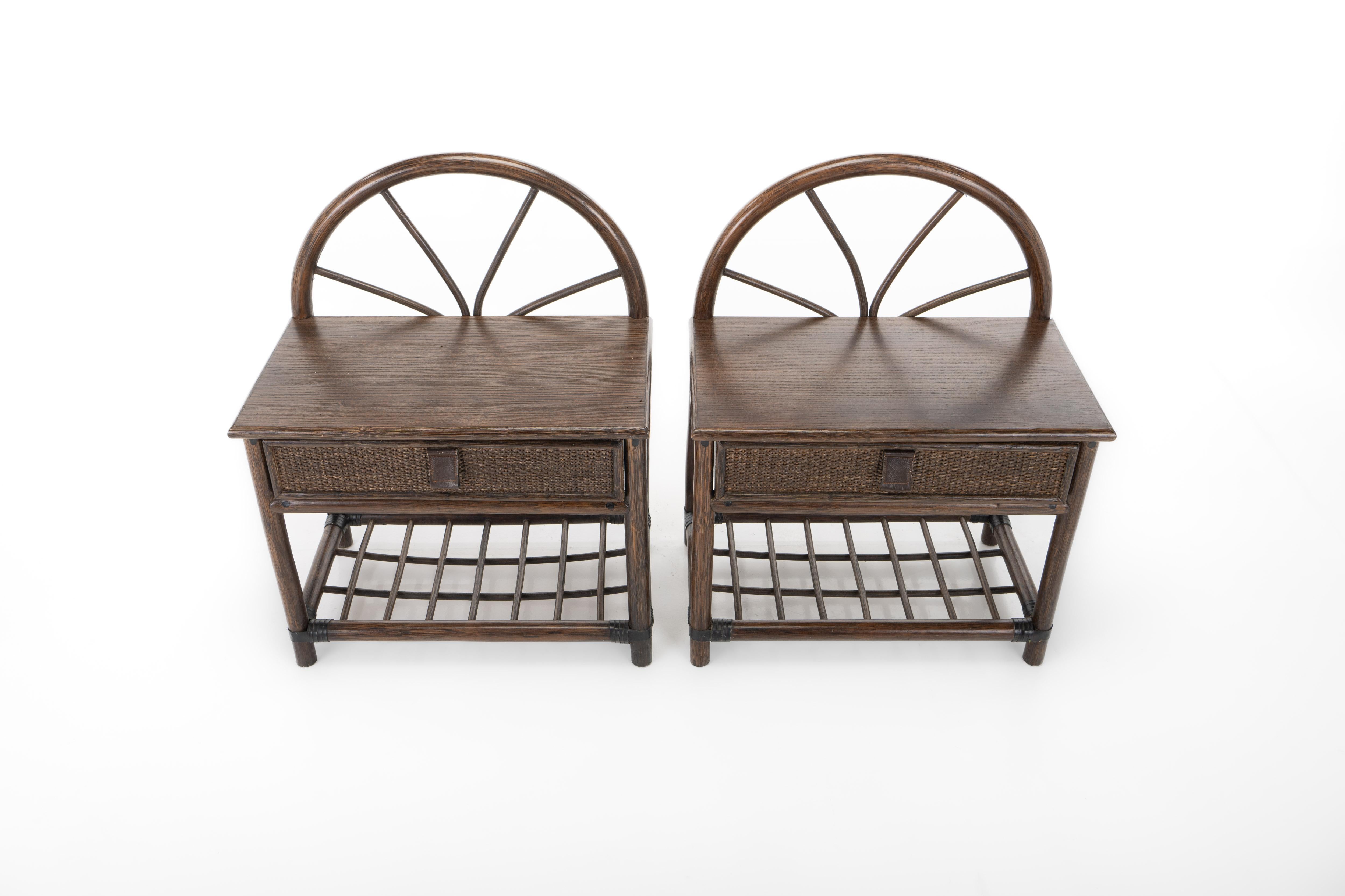 Pair of bedside tables in bamboo and rattan. The tables each have a drawer with a leather handle. An extra nice detail is the curved top in the shape of a sun.