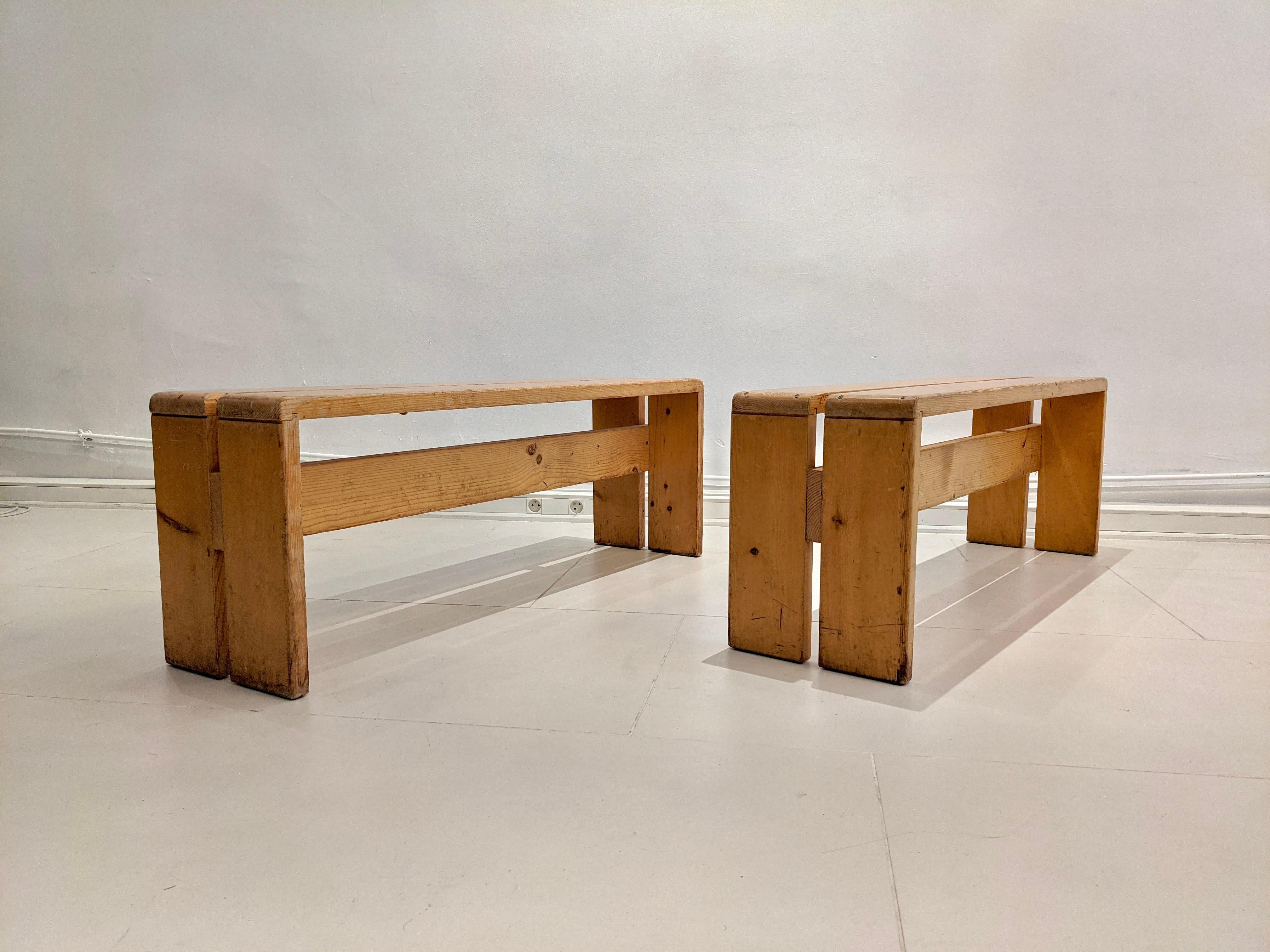 Set of 2 benches in pinewood by Charlotte Perriand for Les Arcs. Light wear on the wood and the screws consistent with age and use.
  