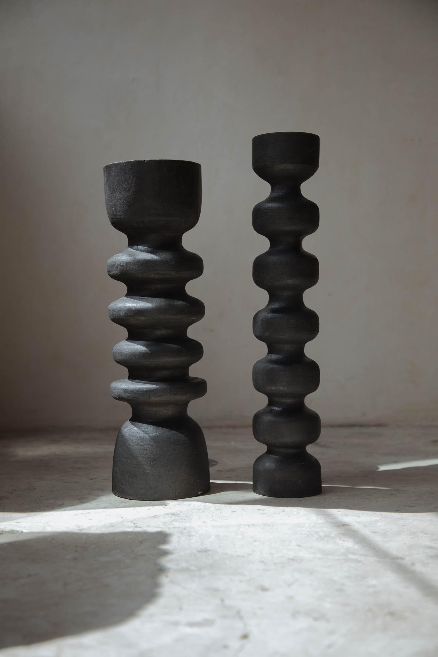 Set of 2 Black Burned Totem candleholders by Daniel Orozco
Material: Black burned solid wood.
Dimensions: D 14 x H 50.8 cm , D 12.7 x H 48.3 cm.

2 black burned wood candle holders. Handmade by Mexican Artisans.

Daniel Orozco Estudio
We are an