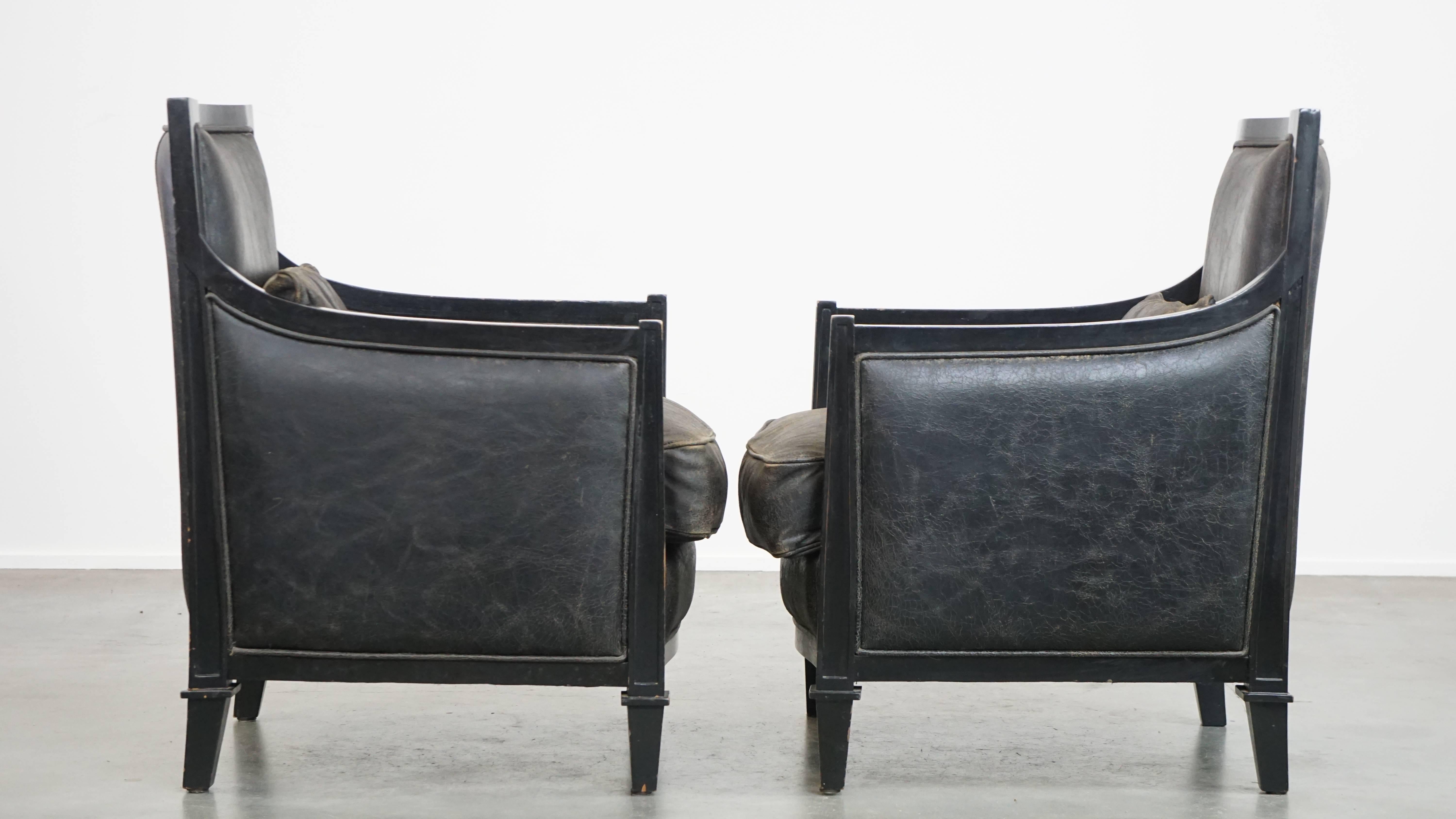 Packed with character, this set of 2 unique cowhide leather armchairs also exudes the timeless luxury and charm of Art Deco design. Their deep black color, combination with wood and sleek finish enhance this character. These armchairs come with